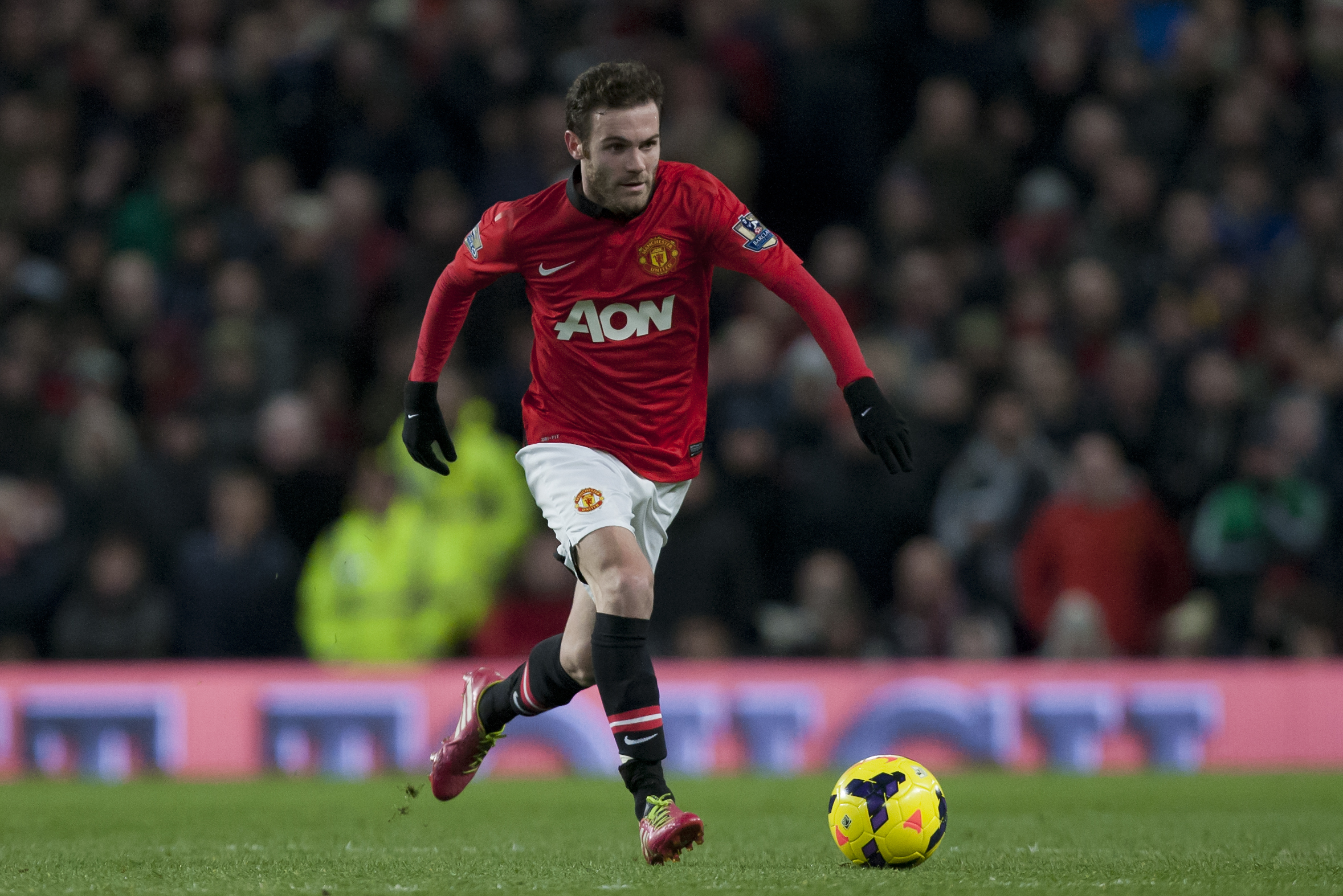 Manchester United's Juan Mata takes the ball downfield during his team's 2-0 win against Cardiff City in their English Premier League soccer match at Old Trafford Stadium, Manchester, England, Tuesday Jan. 28, 2014. (AP Photo/Jon Super)