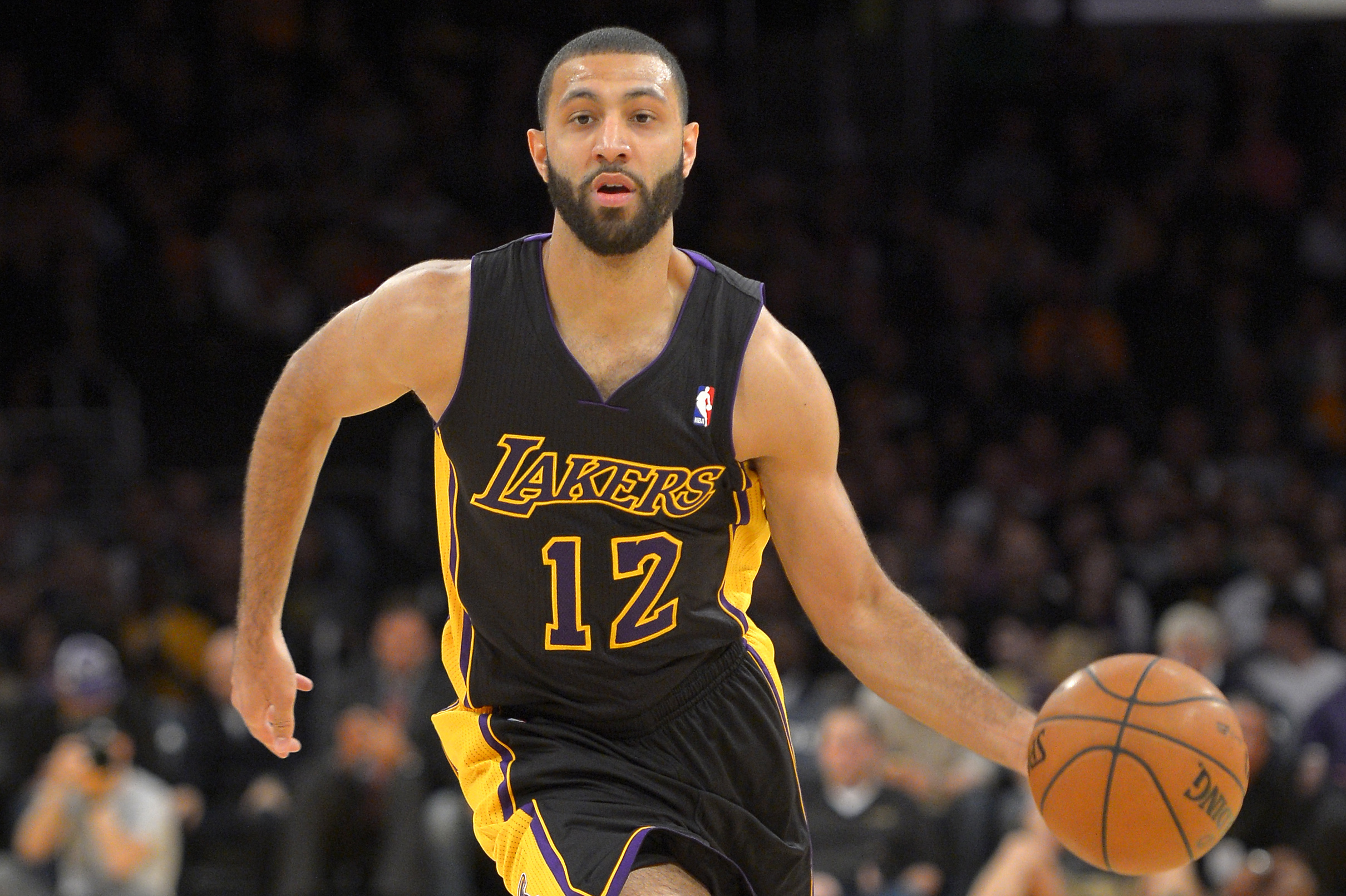 Los Angeles Lakers guard Kendall Marshall dribbles the ball during the first half of an NBA basketball game against the Charlotte Bobcats, Friday, Jan. 31, 2014, in Los Angeles. (AP Photo/Mark J. Terrill)