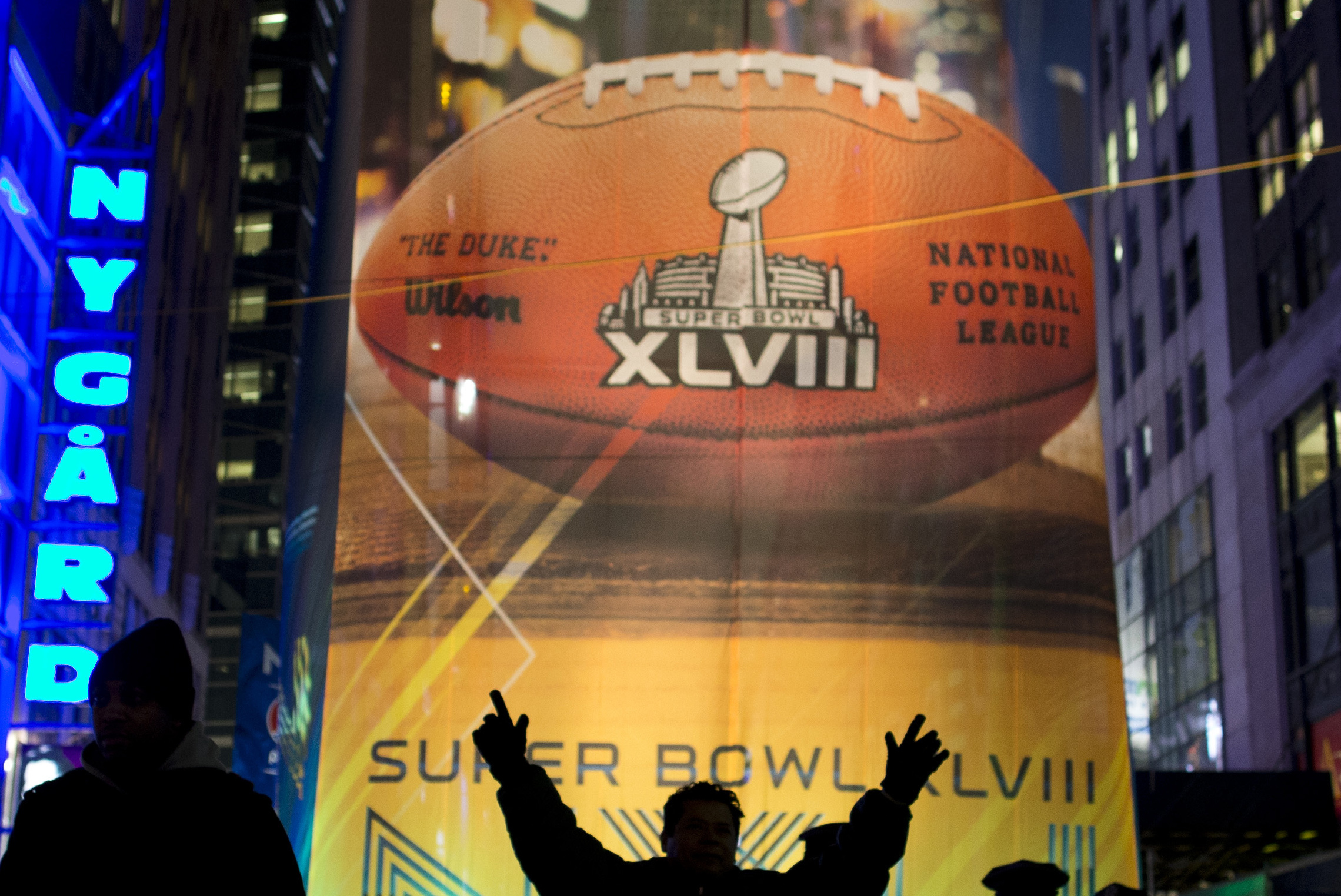 Fans gather on the Super Bowl Boulevard in Times Square on Friday, Jan. 31, 2014, in New York. The Seattle Seahawks will play the Denver Broncos on Sunday in NFL football's Super Bowl XLVIII in East Rutherford, N.J. (AP Photo/ Evan Vucci)