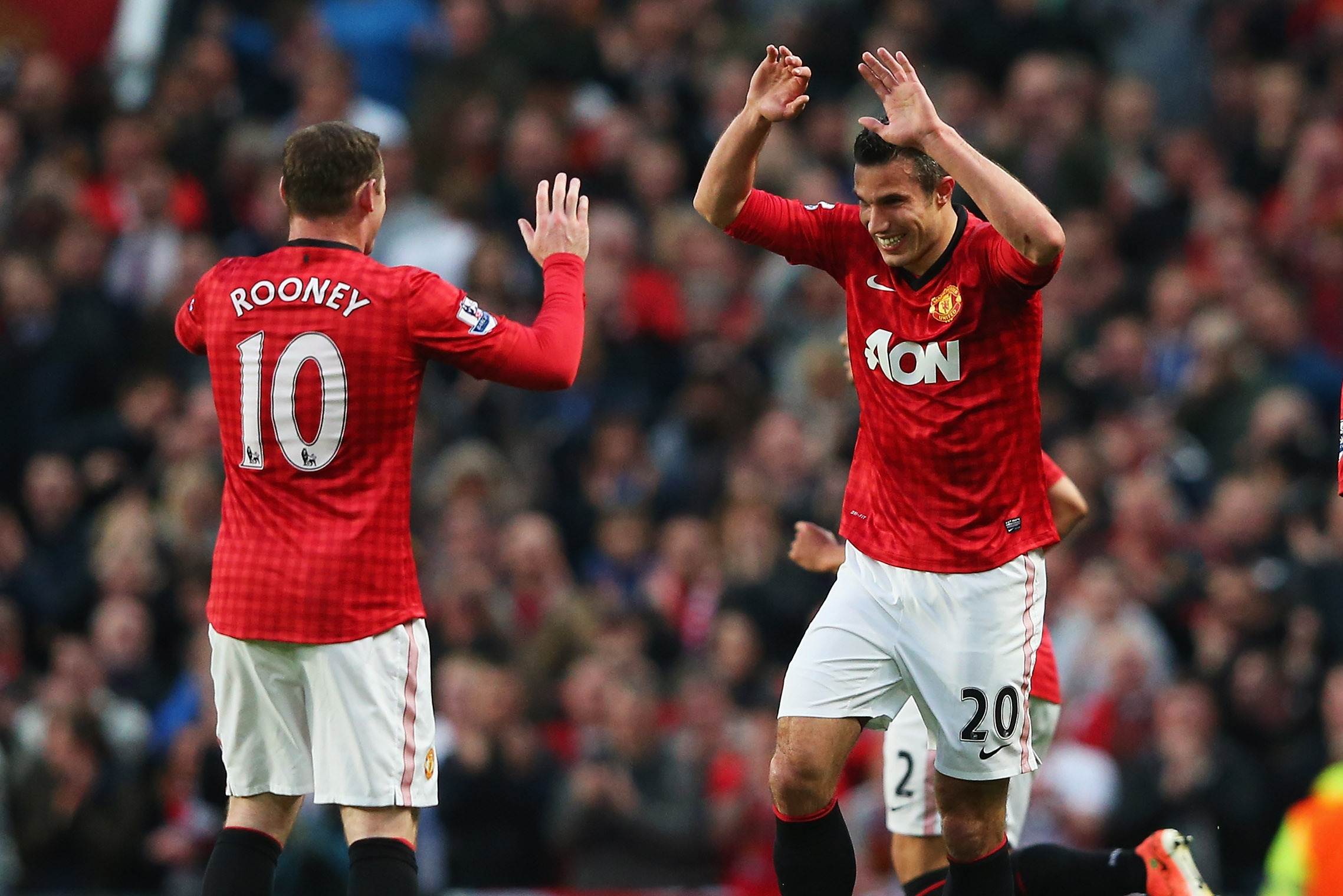 MANCHESTER, ENGLAND - APRIL 22:  Robin van Persie of Manchester United celebrates scoring his second goal with Wayne Rooney and Shinji Kagawa during the Barclays Premier League match between Manchester United and Aston Villa at Old Trafford on April 22, 2013 in Manchester, England.  (Photo by Alex Livesey/Getty Images)