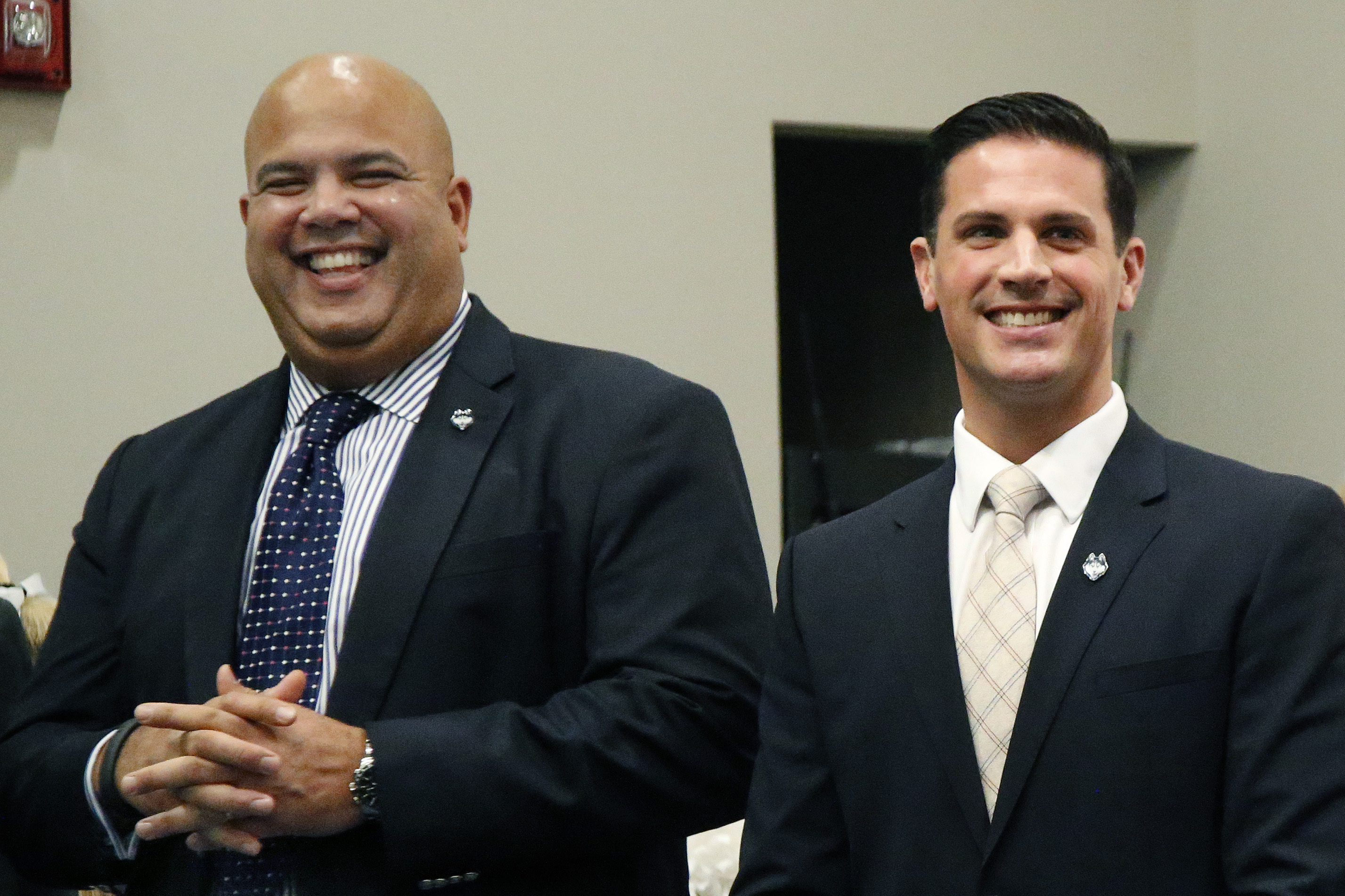 Connecticut athletic director Warde Manuel, left, laughs during a news conference on campus in Storrs, Conn., Thursday, Dec. 12, 2013, held to introduce Bob Diaco, right, as Connecticut's new head football coach. (AP Photo/Elise Amendola)