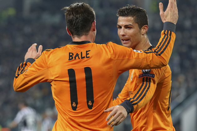 Real's Gareth Bale celebrates with his teammate Cristiano Ronaldo, right, after scoring during a Champions League, Group B, soccer match between Juventus and Real Madrid at the Juventus stadium in Turin, Italy, Tuesday, Nov. 5, 2013. (AP Photo/Antonio Calanni)