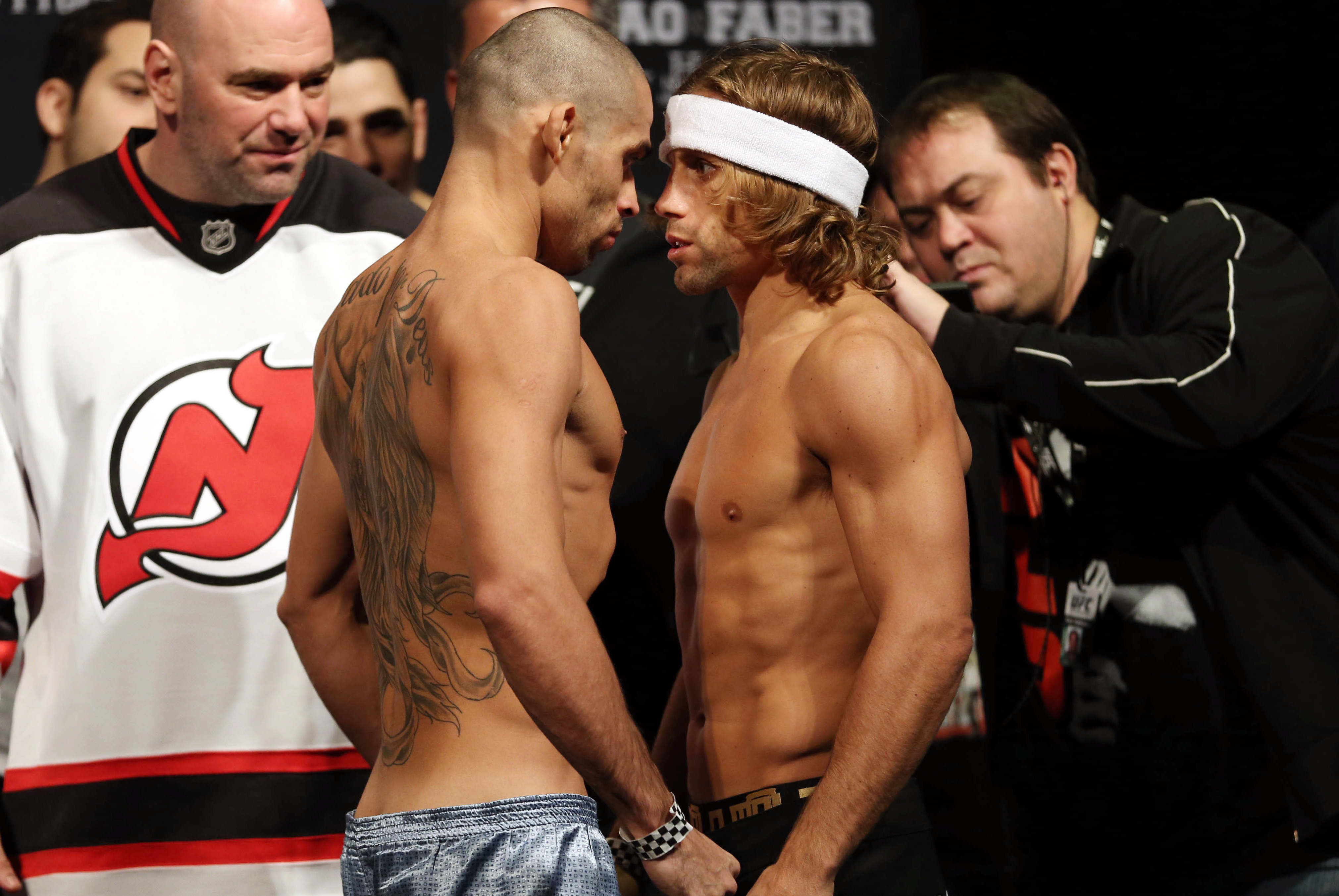 Jan 31, 2014; Newark, NJ, USA; Urijah Faber (right) and Renan Barao (left) face off after weighing in for their Bantamweight Championship bout at Prudential Center. Mandatory Credit: Joe Camporeale-USA TODAY Sports
