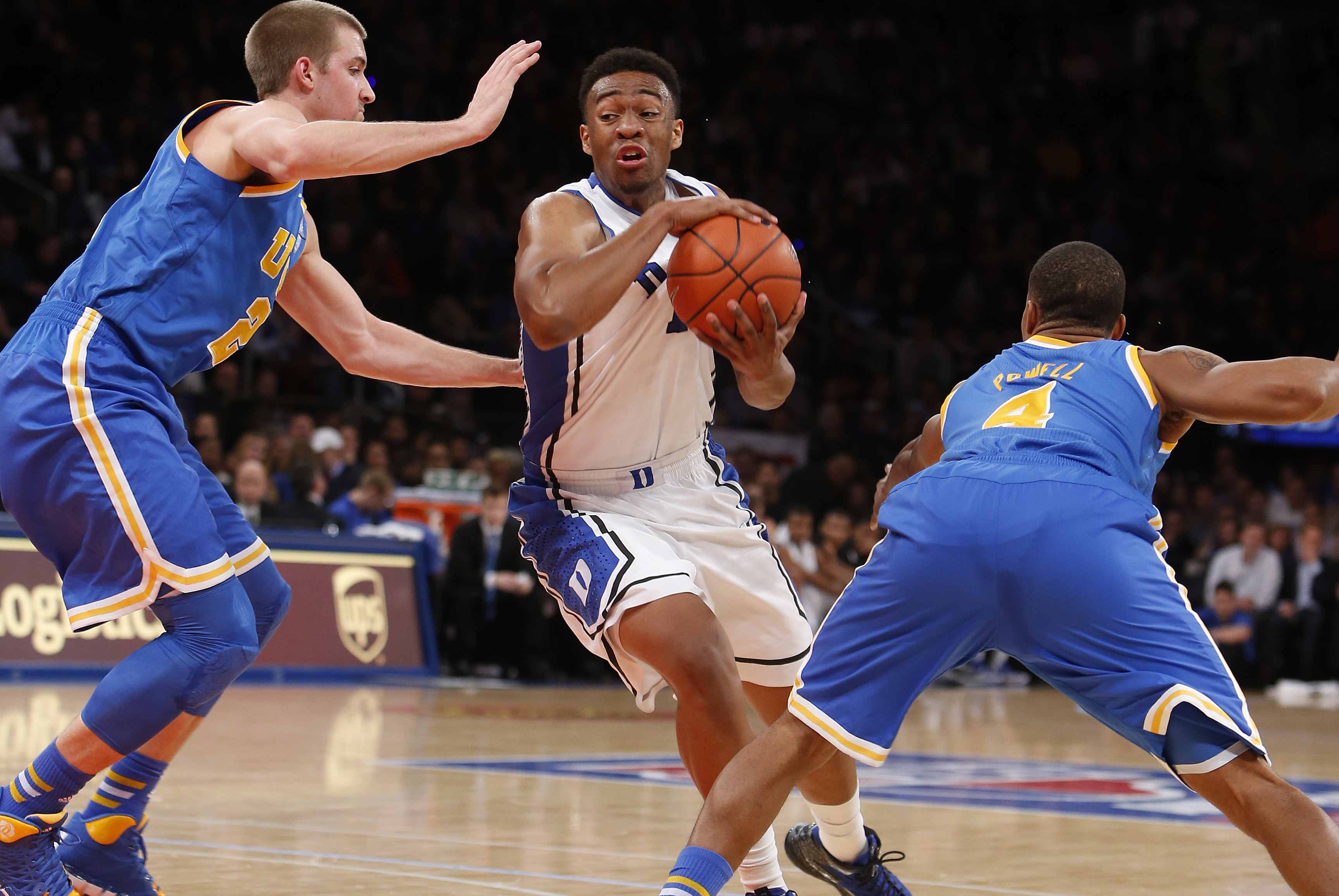 Duke's Jabari Parker, center, drives between UCLA's Travis Wear, left, and Norman Powell during the first half of an NCAA college basketball game, Thursday, Dec. 19, 2013, in New York. (AP Photo/Jason DeCrow)