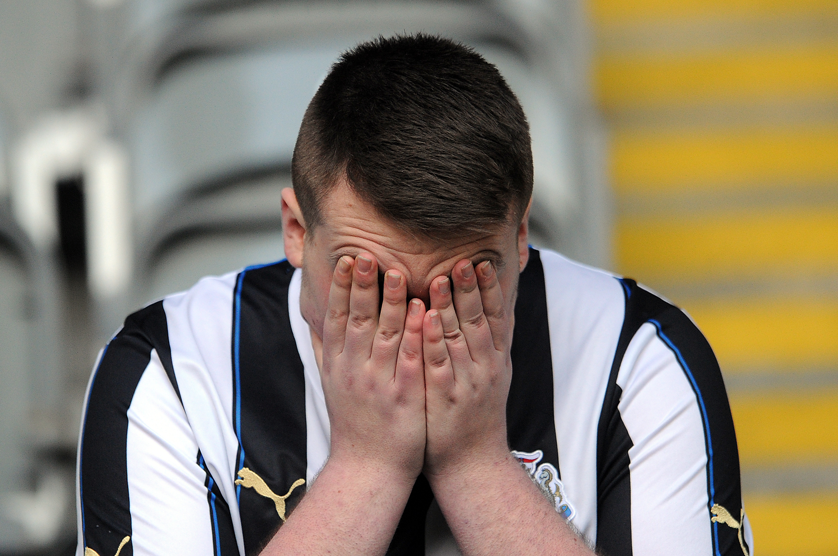 NEWCASTLE UPON TYNE, ENGLAND - FEBRUARY 01: A Newcastle United fan looks dejected following the Barclays Premier League match between Newcastle United and Sunderland at St James' Park on February 01, 2014 in Newcastle upon Tyne, England. (Photo by Chris Brunskill/Getty Images)