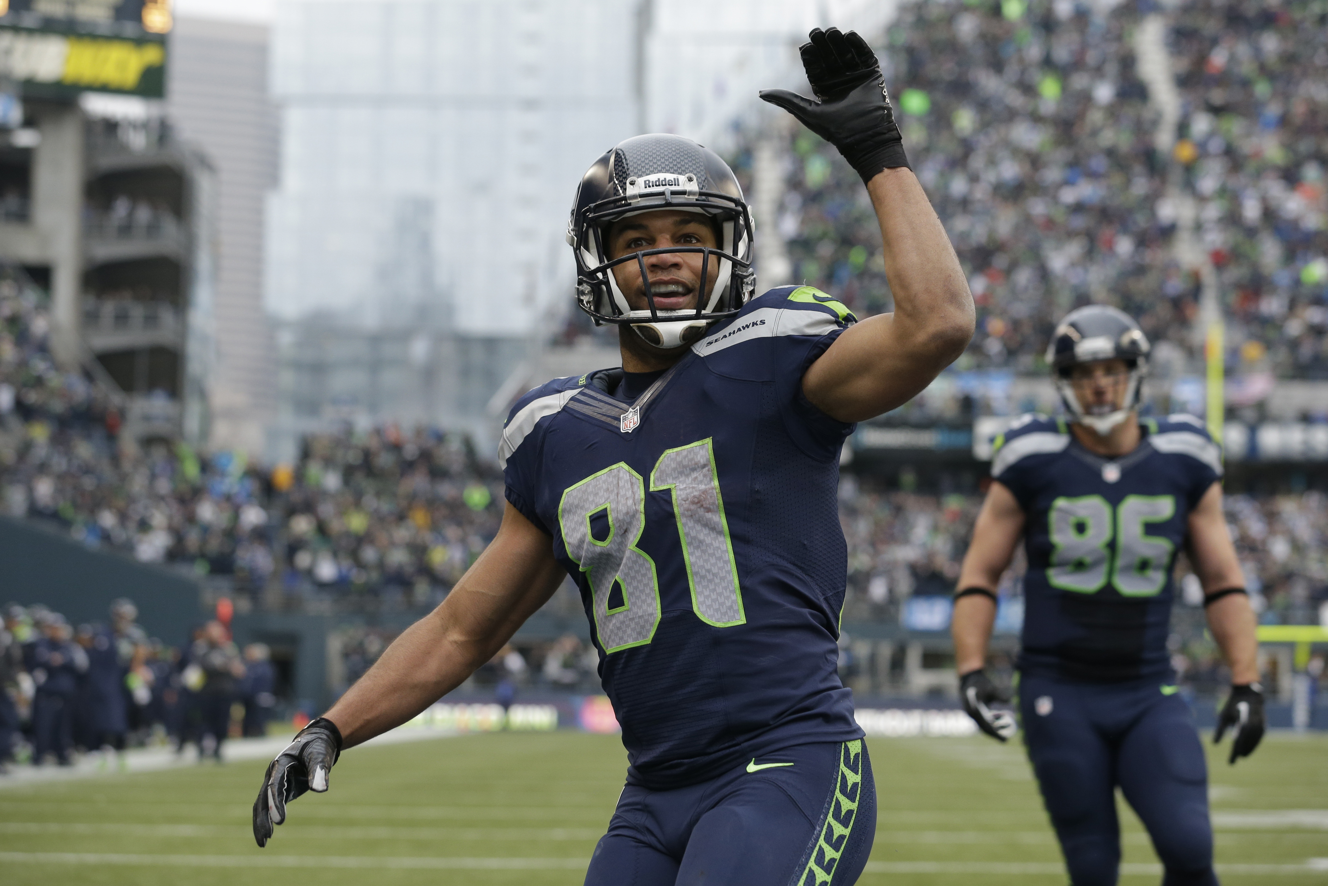 Seattle Seahawks' Golden Tate motions to fans after scoring against the St. Louis Rams in the second half of an NFL football game, Sunday, Dec. 29, 2013, in Seattle. (AP Photo/Elaine Thompson)
