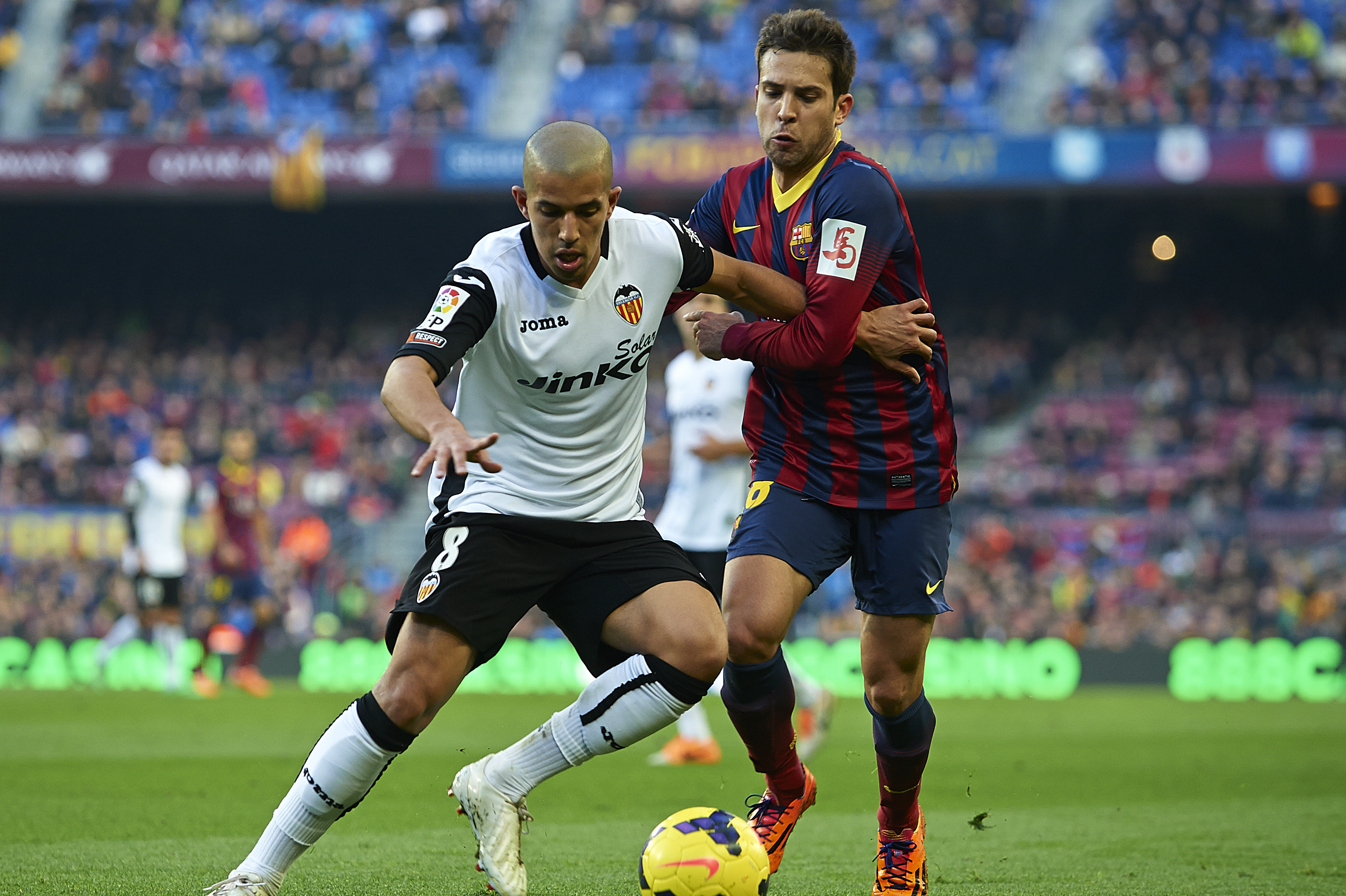 BARCELONA, SPAIN - FEBRUARY 01:   Jordi Alba (R) of FC Barcelona competes for the ball with Sofiane Feghouli of Valencia CF during the La Liga match between FC Barcelona and Valencia CF at Camp Nou on February 1, 2014 in Barcelona, Spain.  (Photo by Manuel Queimadelos Alonso/Getty Images)