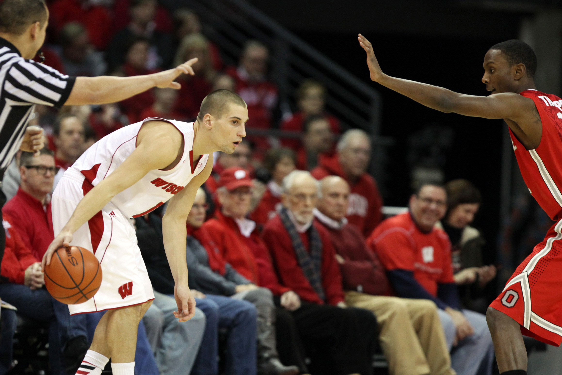 Feb 1, 2014; Madison, WI, USA; Wisconsin Badgers guard Ben Brust (1) looks to pass as Ohio State Buckeyes forward Sam Thompson (12) defends during the first half at the Kohl Center. Mandatory Credit: Mary Langenfeld-USA TODAY Sports