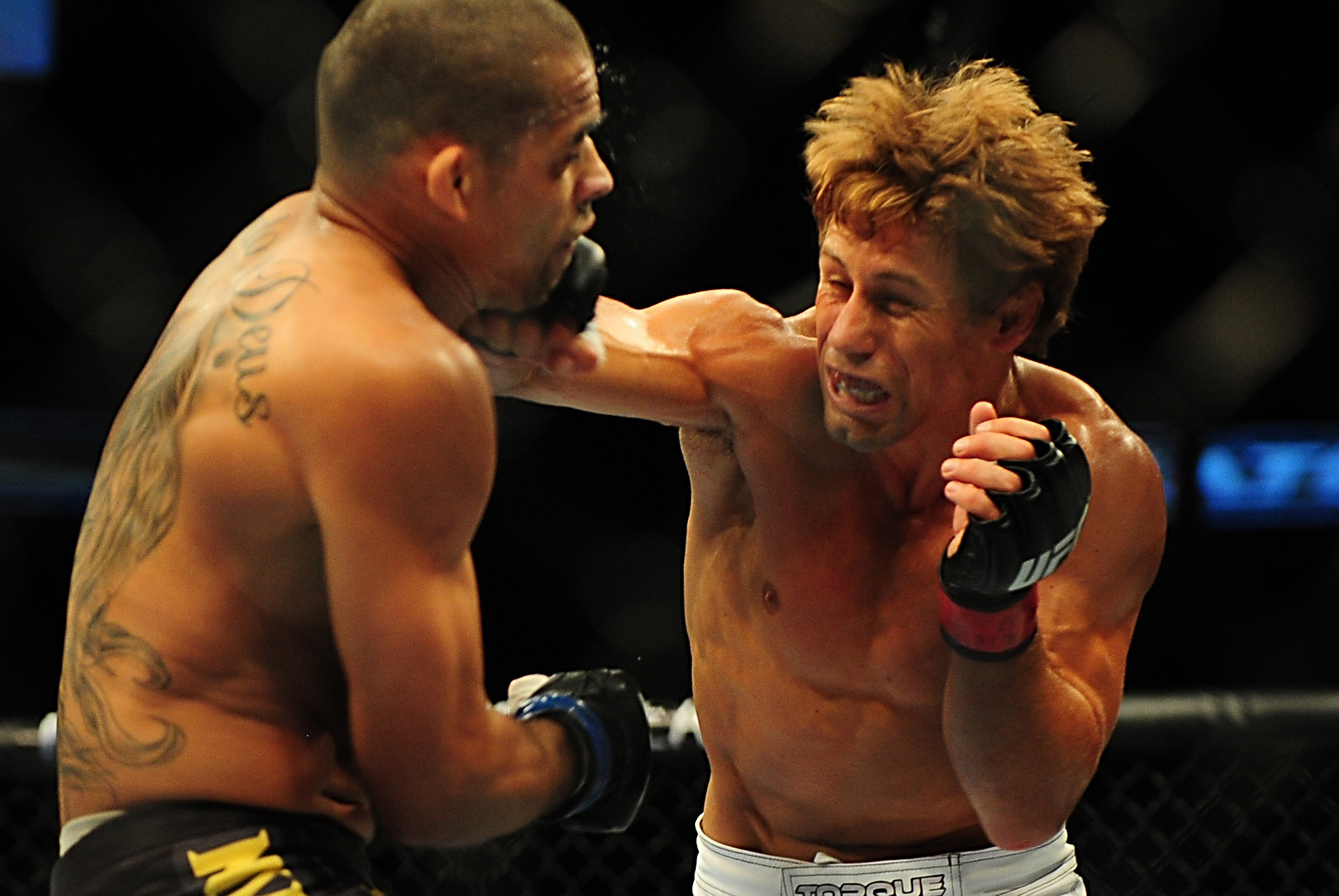 Jul 21, 2012; Calgary, AB, CANADA; Renan Barao (blue golves) and Urijah Faber (red gloves) during the interim bantamweight title bout of UFC 149 at the Scotiabank Saddledome. Mandatory Credit: Anne-Marie Sorvin-USA TODAY Sports