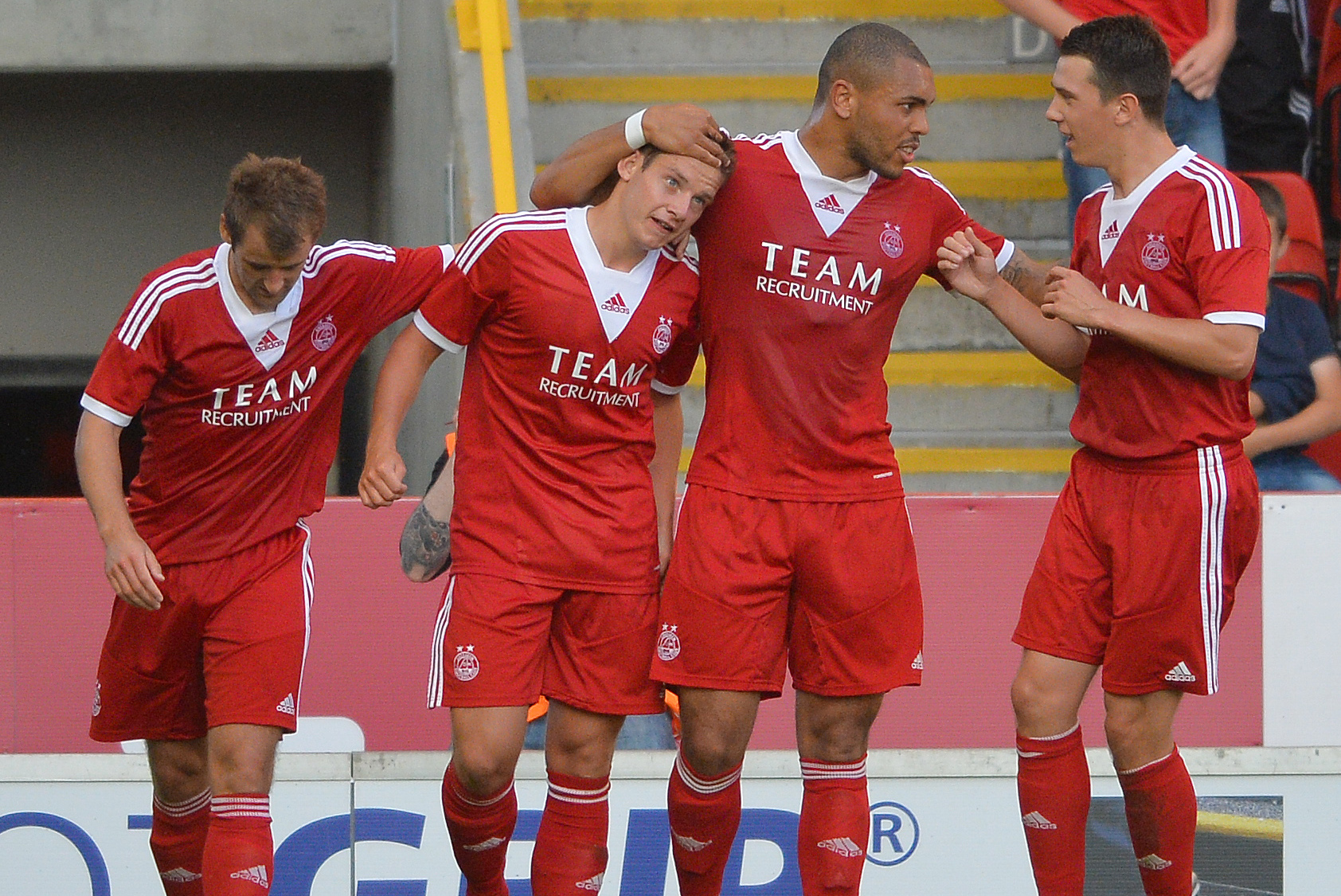 ABERDEEN, SCOTLAND - JULY 26:  Peter Pawlett (2nd R) of Aberdeen celebrates his goal with his team-mates Naill McGinn (L) and Josh Magennis (2nd R) during the Pre Season Friendly match between Aberdeen and FC Twente at Pittodrie Stadium on July 26, 2013 in Aberdeen, Scotland. (Photo by Mark Runnacles/Getty Images)