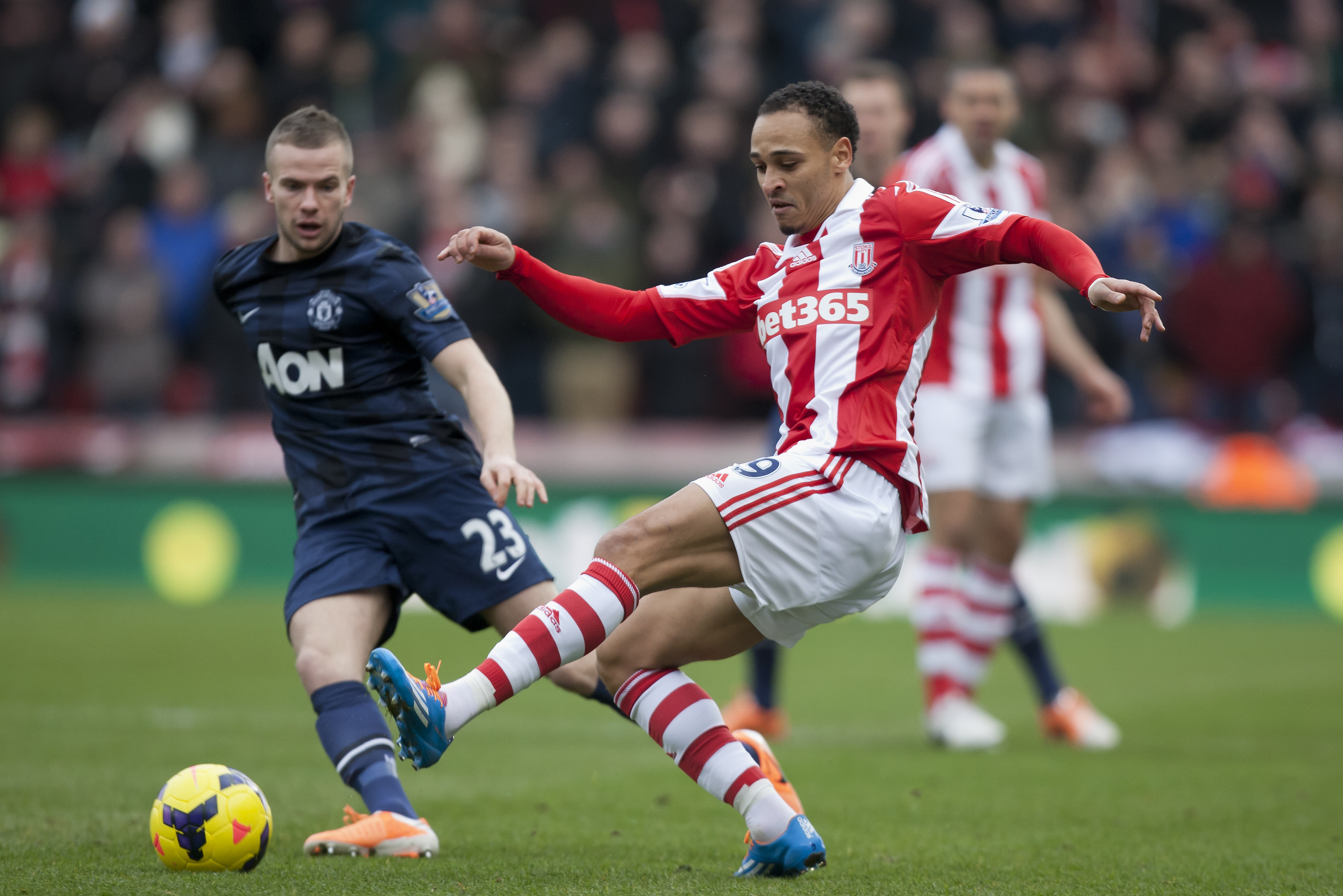 Stoke's Peter Odemwingie, centre, keeps the ball from Manchester United's Tom Cleverley during their English Premier League soccer match at the Britannia Stadium, Stoke, England, Saturday Feb. 1, 2014. (AP Photo/Jon Super)