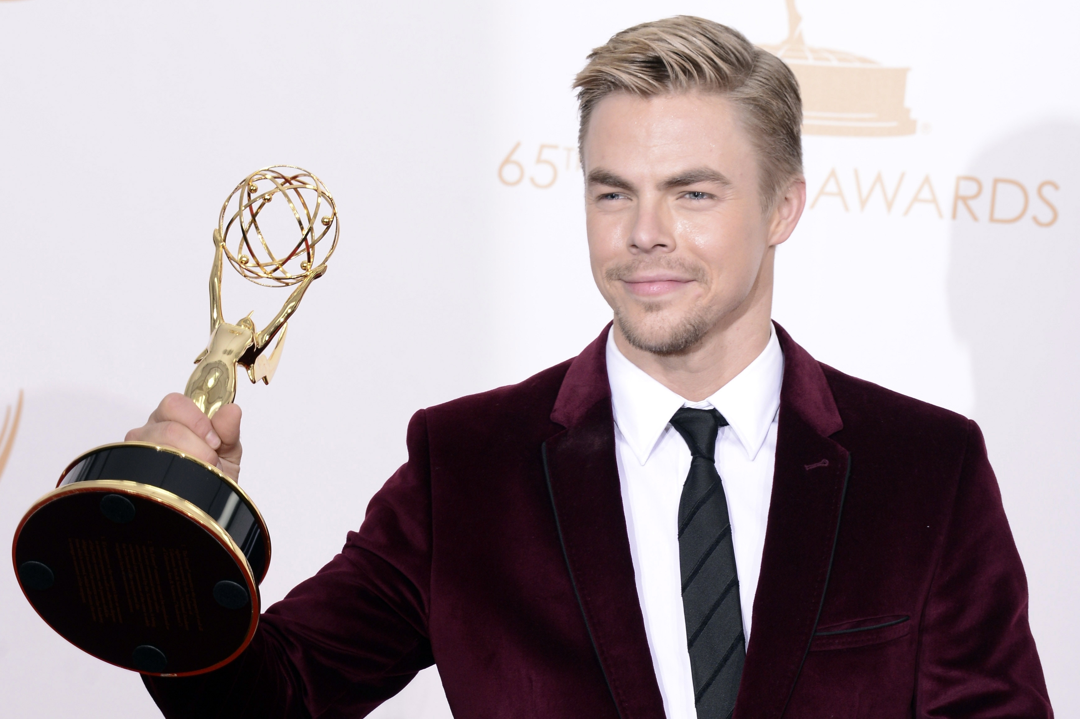 Derek Hough poses backstage with the award for Outstanding Choreography for