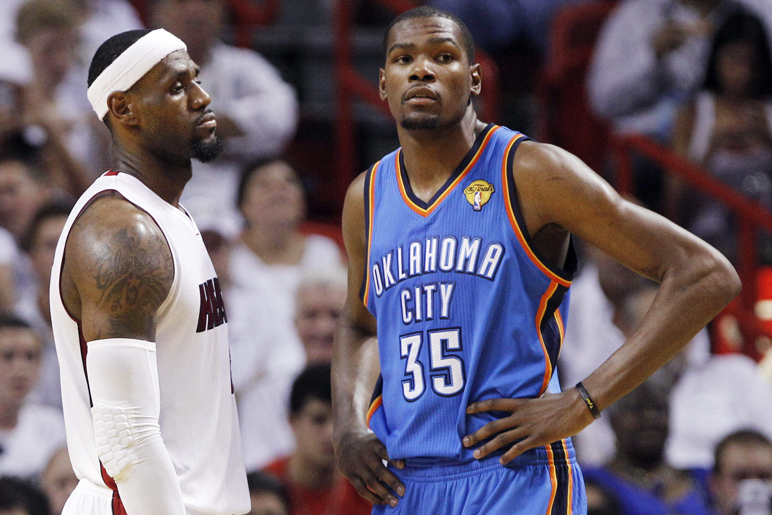 Miami Heat small forward LeBron James (6) and Oklahoma City Thunder small forward Kevin Durant (35) pause between plays during the first half at  Game 5 of the NBA finals basketball series, Thursday, June 21, 2012, in Miami. (AP Photo/Lynne Sladky)