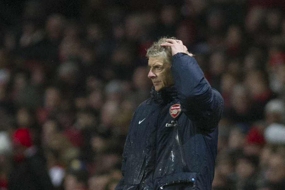 Arsenal's manager Arsene Wenger, looks on during their English Premier League match against Cardiff City, at Emirates Stadium, in London, Wednesday, Jan. 1, 2014. (AP Photo/Bogdan Maran)