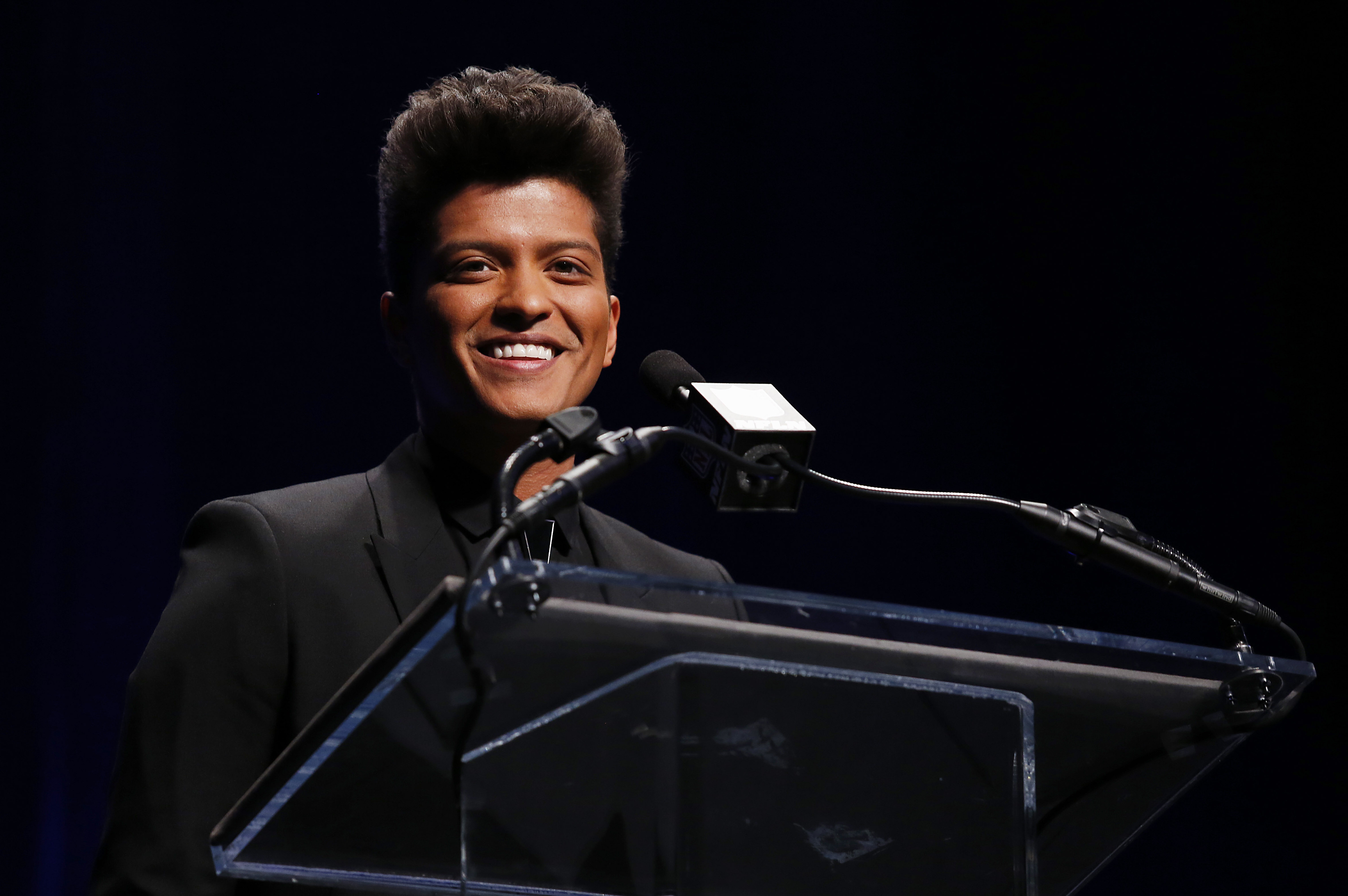Singer Bruno Mars speaks during a press conference to discuss his performance during the Super Bowl XLVIII halftime show, Thursday, Jan. 30, 2014, in New York. (AP Photo/Doug Benc)