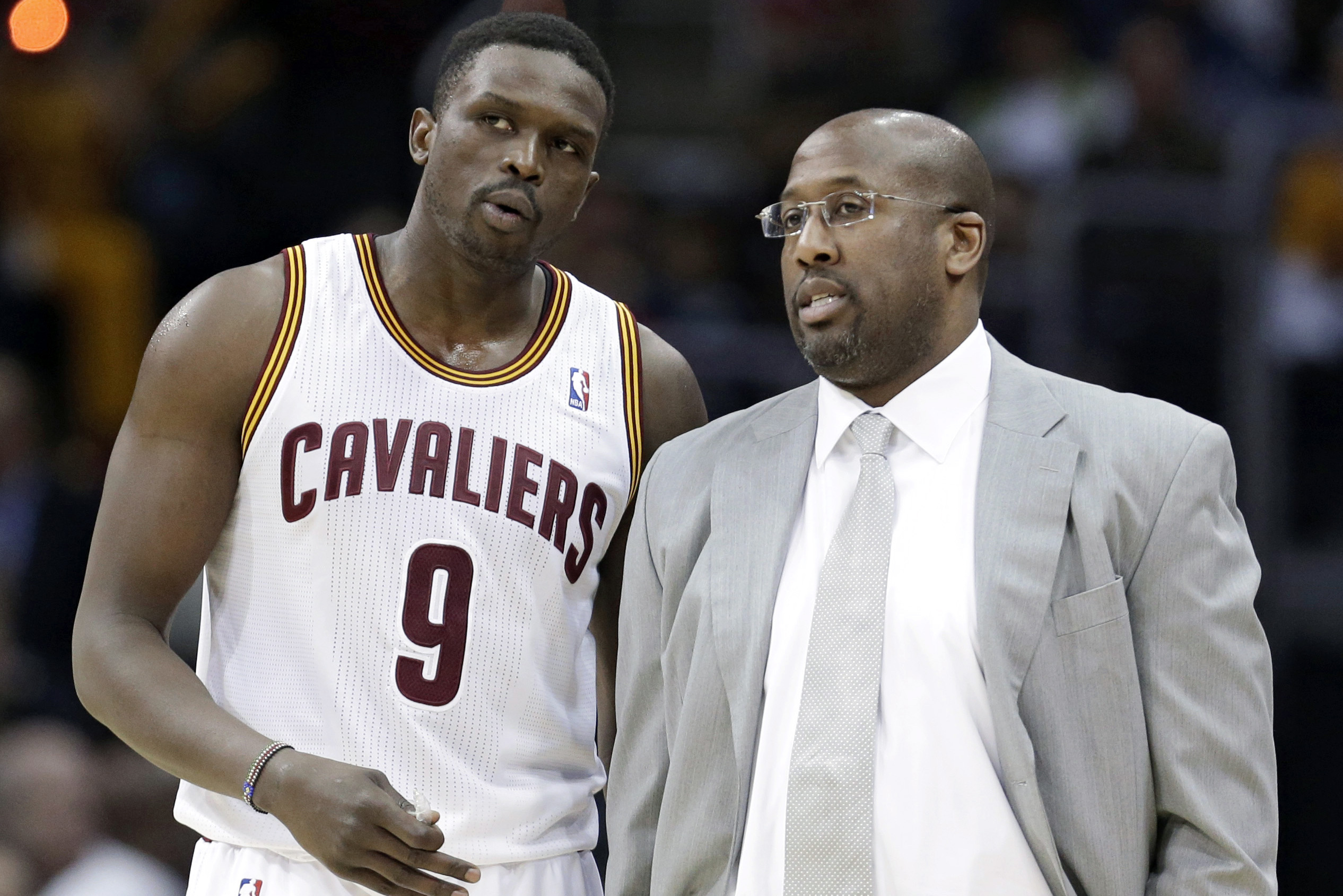 Cleveland Cavaliers head coach Mike Brown, right, talks with Luol Deng during the third quarter of an NBA basketball game, Monday, Jan. 20, 2014, in Cleveland. Dallas defeated Cleveland 102-97. (AP Photo/Tony Dejak)