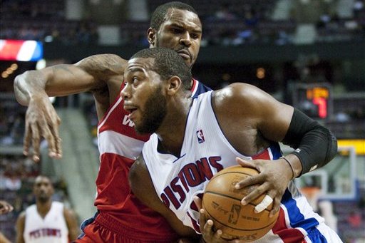 Detroit Pistons' Greg Monroe, front, drives to the basket against Washington Wizards' Trevor Booker in the second half of an NBA basketball game, Sunday, Feb. 12, 2012, in Auburn Hills, Mich. The Wizards won 98-77. (AP Photo/Duane Burleson)