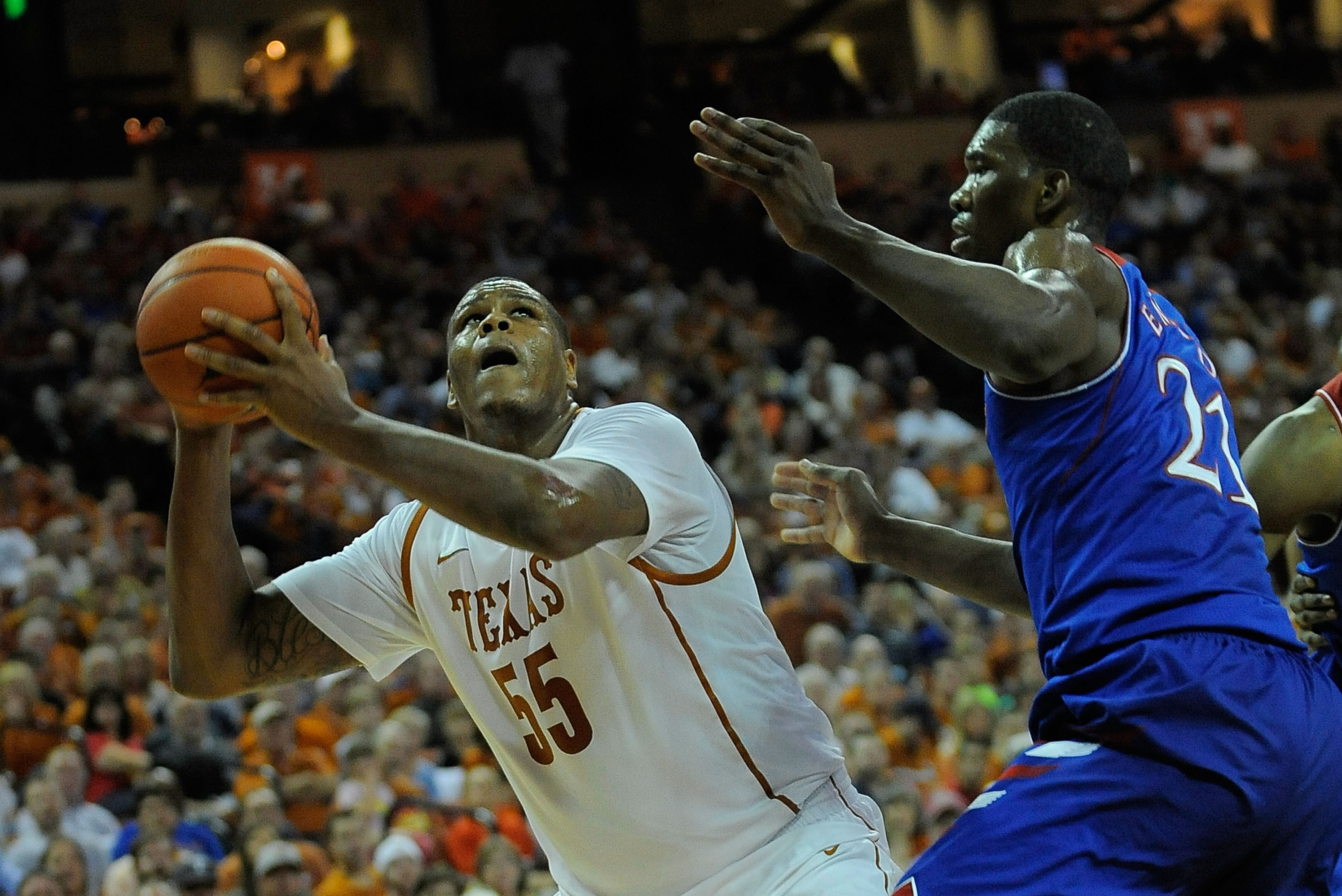 AUSTIN, TX - FEBRUARY 01:  Cameron Ridley #55 of the Texas Longhorns is defended by Joel Embiid #21 of the Kansas Jayhawks during a game at The Frank Erwin Center on February 1, 2014 in Austin, Texas.  (Photo by Stacy Revere/Getty Images)