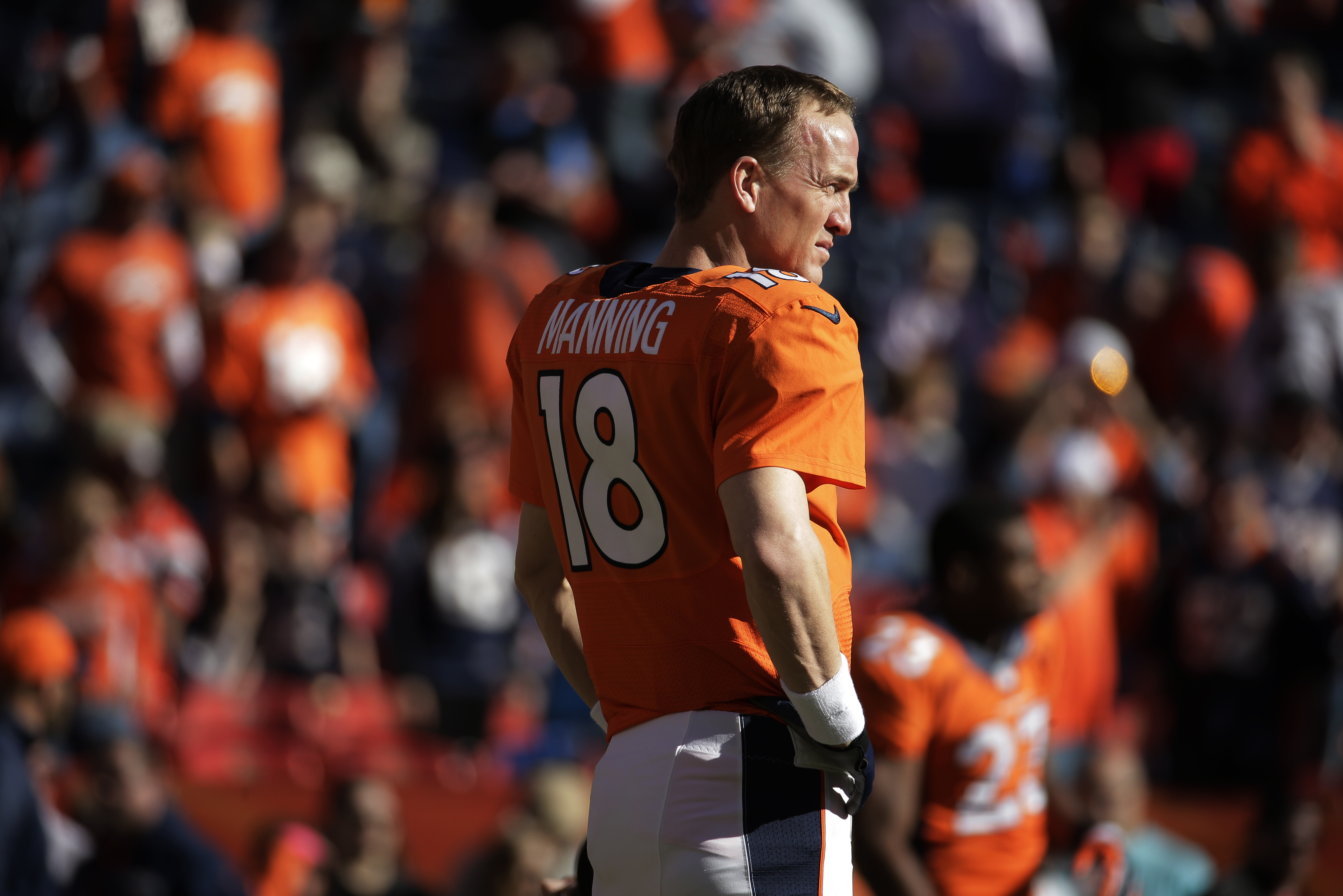 Denver Broncos quarterback Peyton Manning (18) warms up before the AFC Championship NFL playoff football game against the New England Patriots in Denver, Sunday, Jan. 19, 2014. (AP Photo/Charlie Riedel)