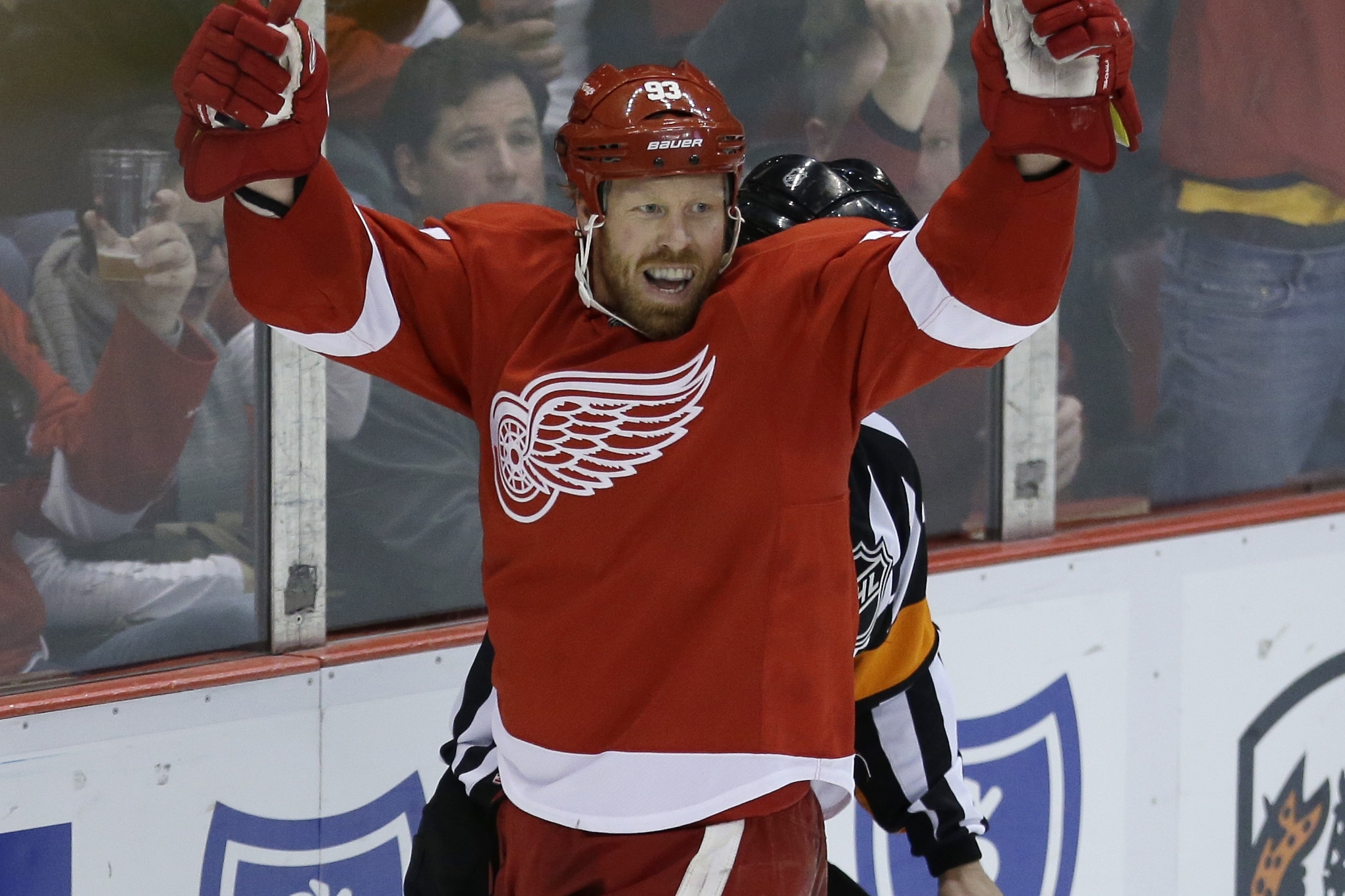 Detroit Red Wings left wing Johan Franzen (93) of Sweden celebrates the goal by teammate Henrik Zetterberg during the third period of an NHL hockey game against the Carolina Hurricanes in Detroit, Thursday, Nov. 21, 2013. (AP Photo/Carlos Osorio)