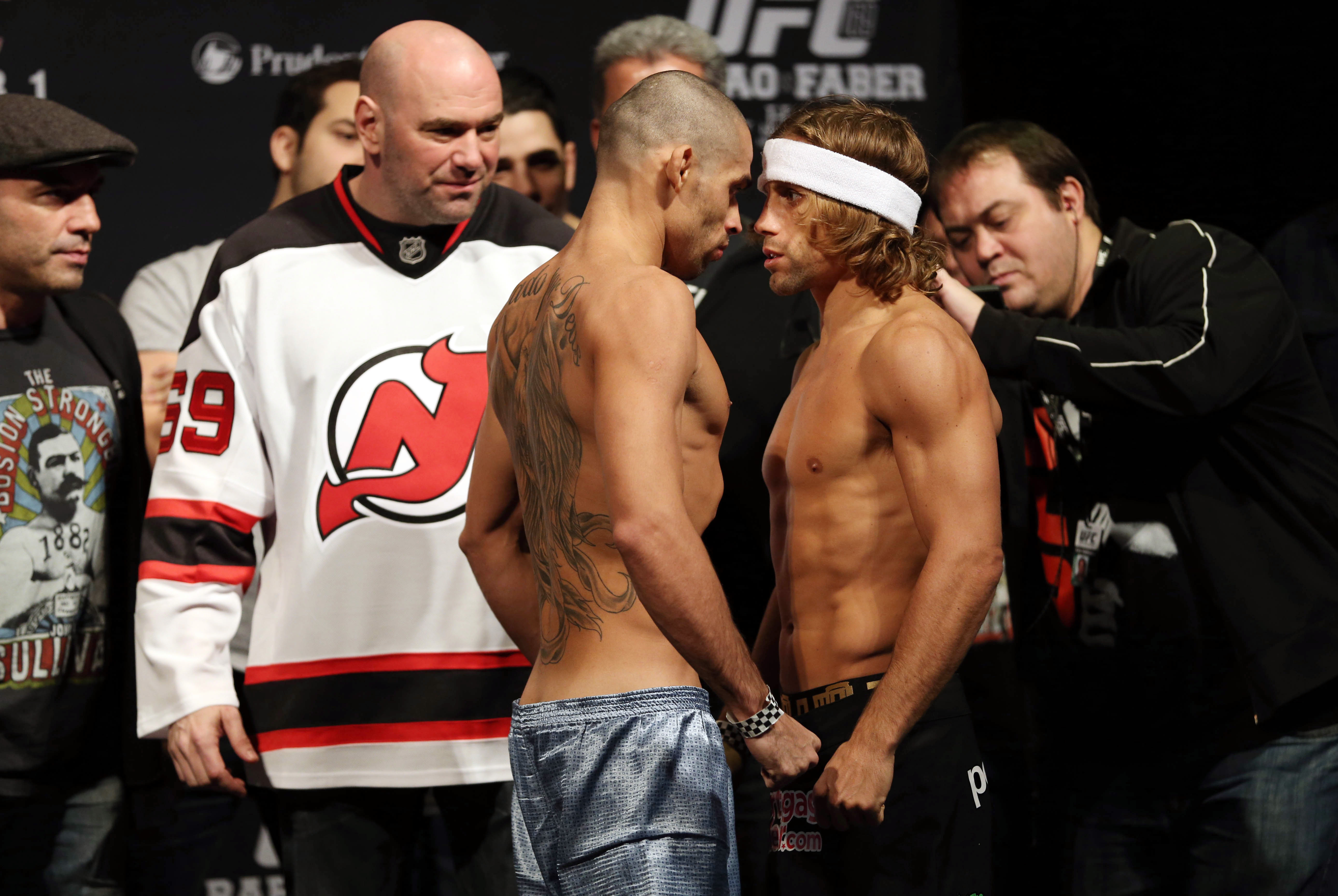 Jan 31, 2014; Newark, NJ, USA; Urijah Faber (right) and Renan Barao (left) face off after weighing in for their Bantamweight Championship bout at Prudential Center. Mandatory Credit: Joe Camporeale-USA TODAY Sports
