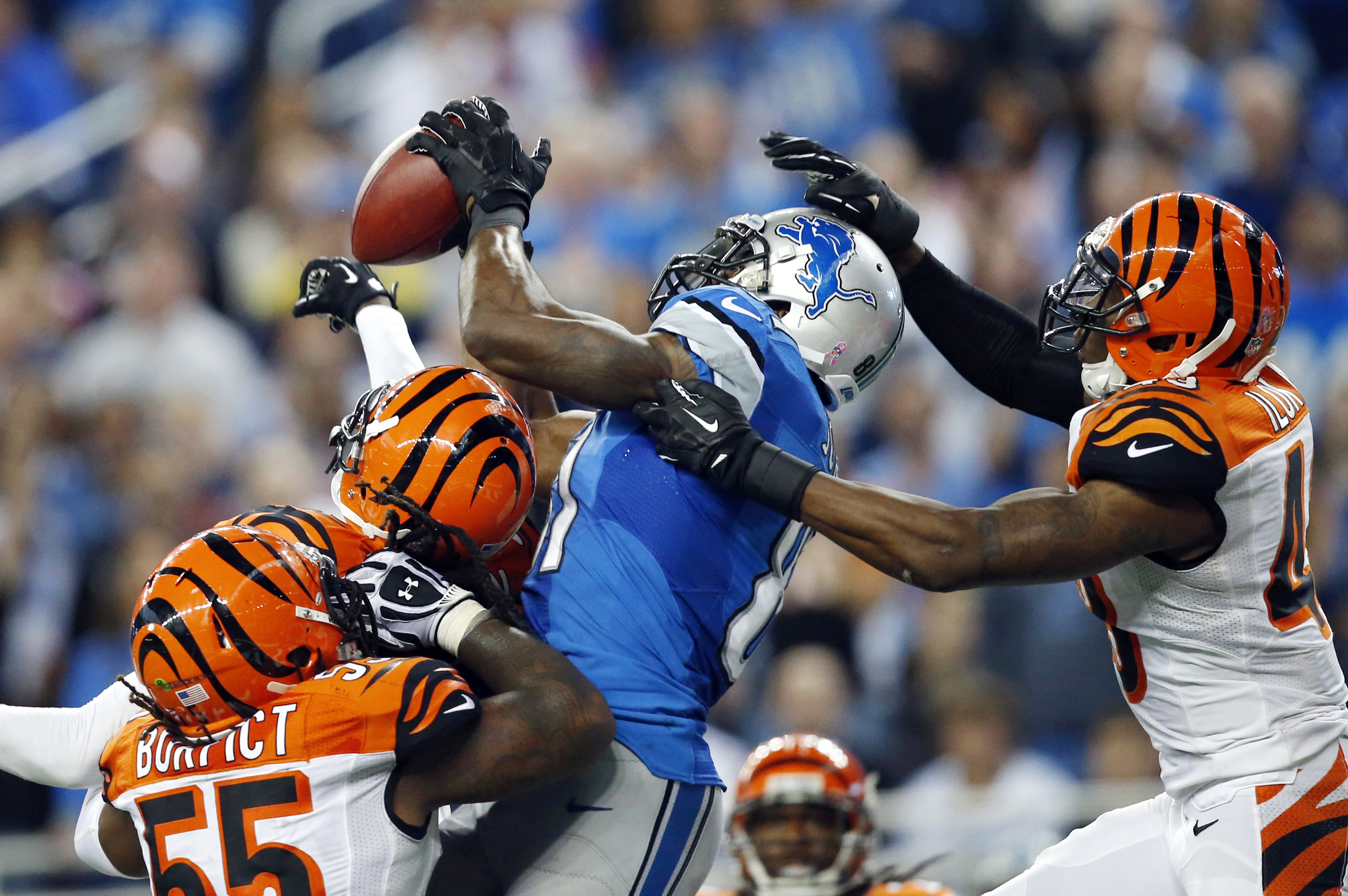 FILE - In this Oct. 20, 2013, file photo, Detroit Lions wide receiver Calvin Johnson, second from right, catches a 50-yard touchdown reception over Cincinnati Bengals outside linebacker Vontaze Burfict, left, free safety Reggie Nelson, second from left, and strong safety George Iloka in the fourth quarter of an NFL football game in Detroit. (AP Photo/Rick Osentoski, File)