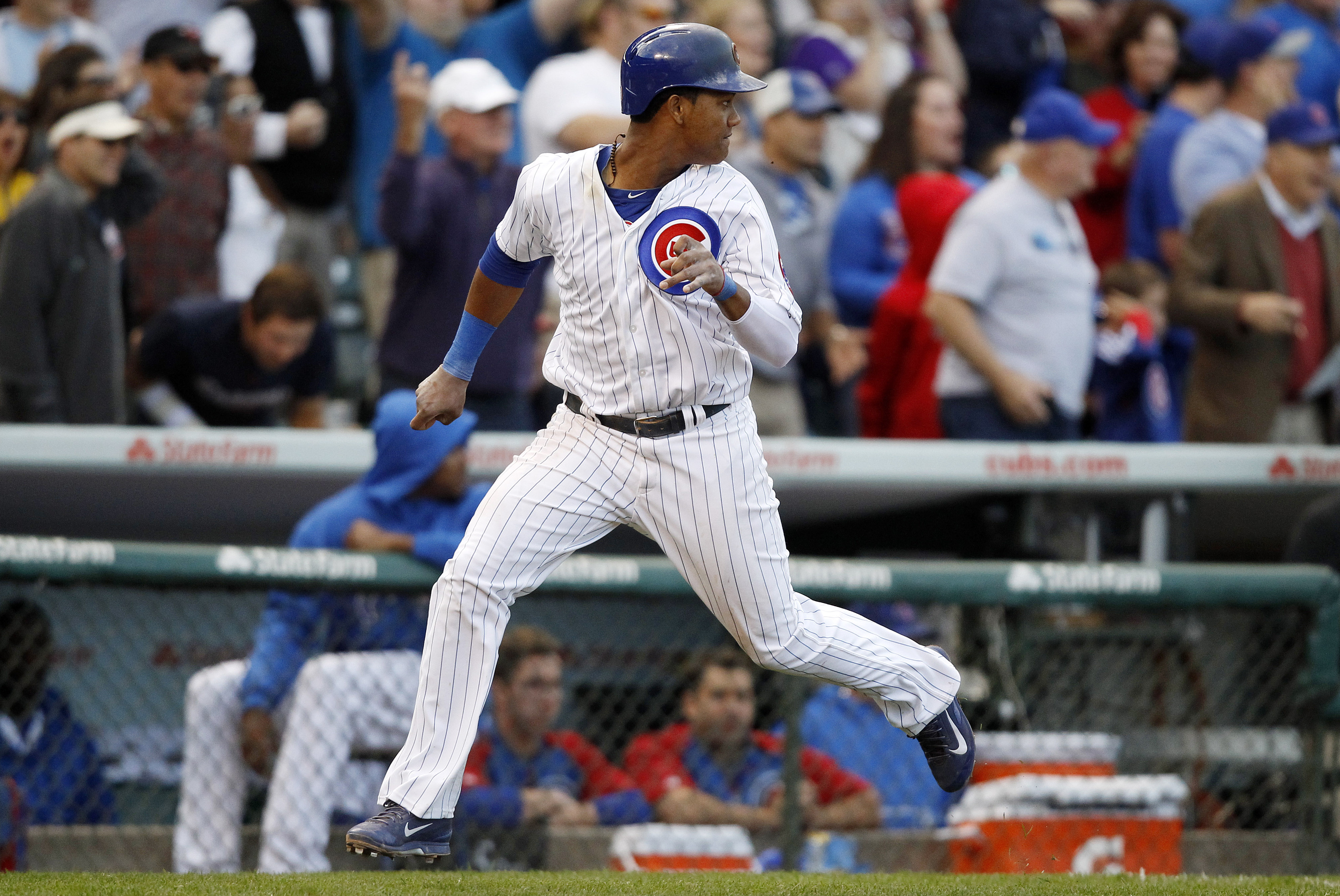 Chicago Cubs' Starlin Castro safely reaches home on a hit by Anthony Rizzo during the eighth inning of a baseball game against the Atlanta Braves on Saturday, Sept. 21, 2013, in Chicago. (AP Photo/Andrew A. Nelles)