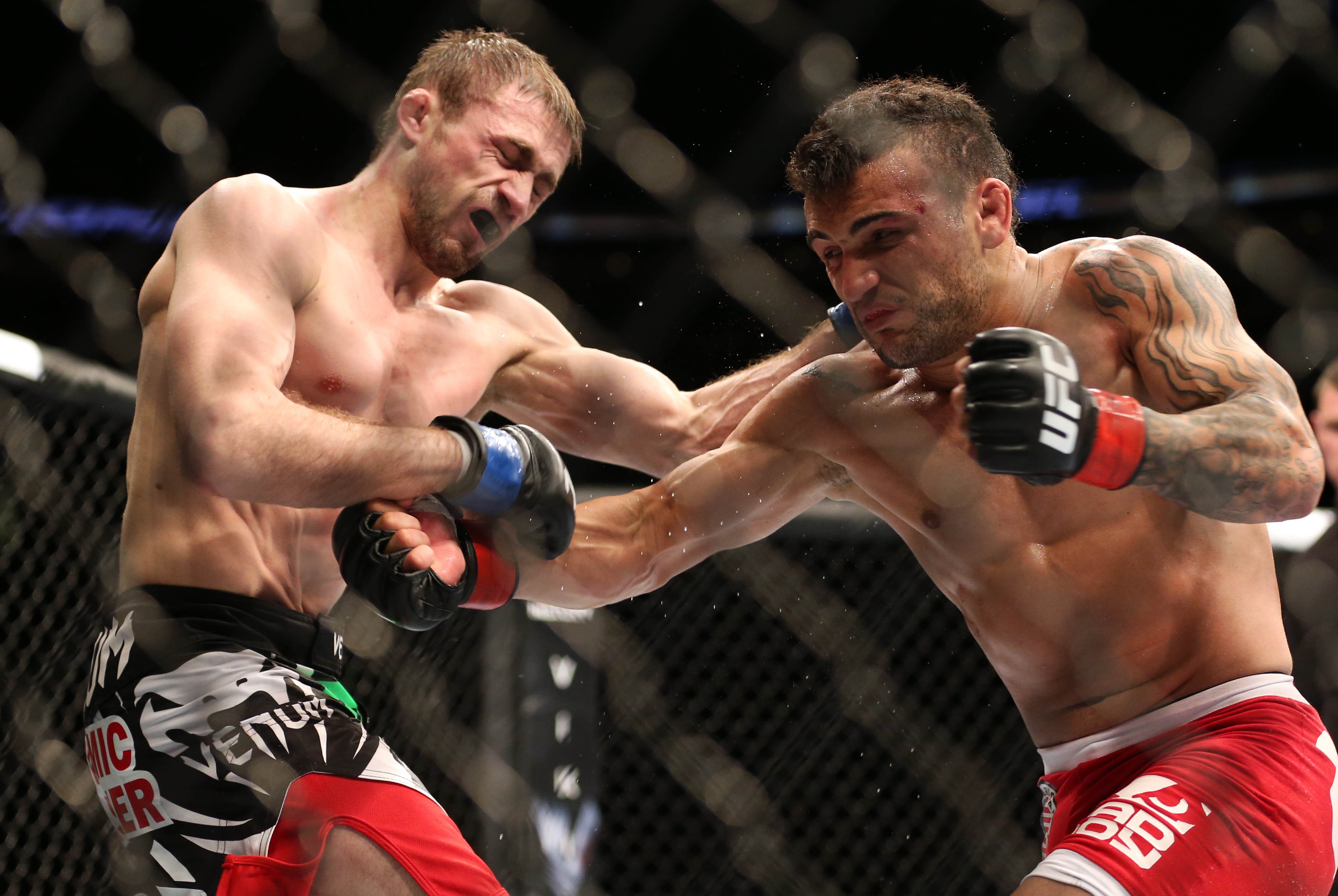 Feb 1, 2014; Newark, NJ, USA; John Lineker (red gloves) fights Ali Bagautinov (blue gloves) during UFC169 at Prudential Center. Mandatory Credit: Joe Camporeale-USA TODAY Sports