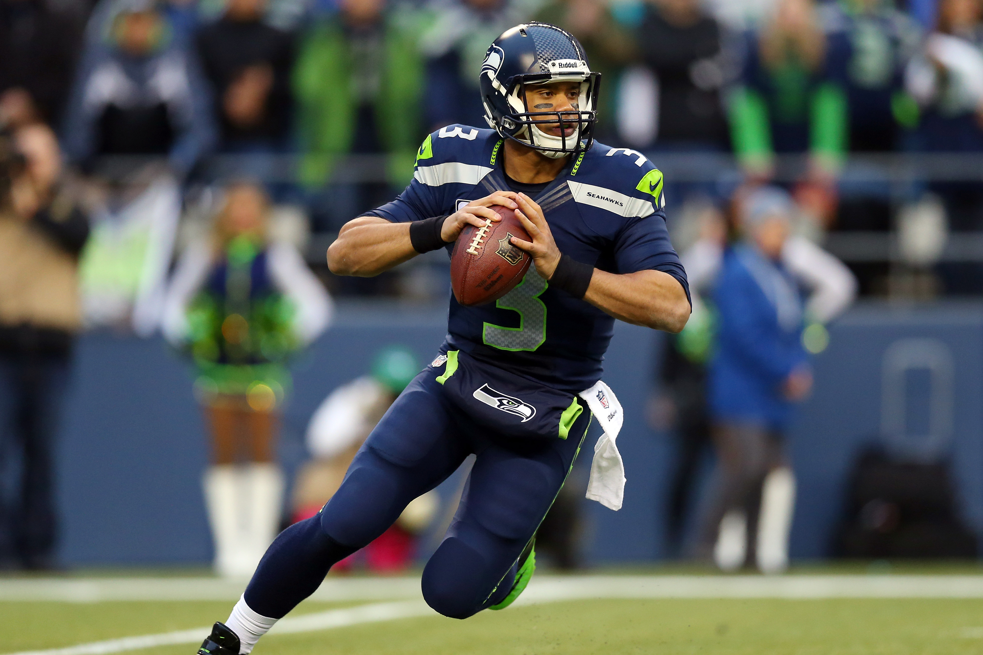 SEATTLE, WA - JANUARY 19:  Quarterback Russell Wilson #3 of the Seattle Seahawks drops back against the San Francisco 49ers during the 2014 NFC Championship at CenturyLink Field on January 19, 2014 in Seattle, Washington.  (Photo by Ronald Martinez/Getty Images)