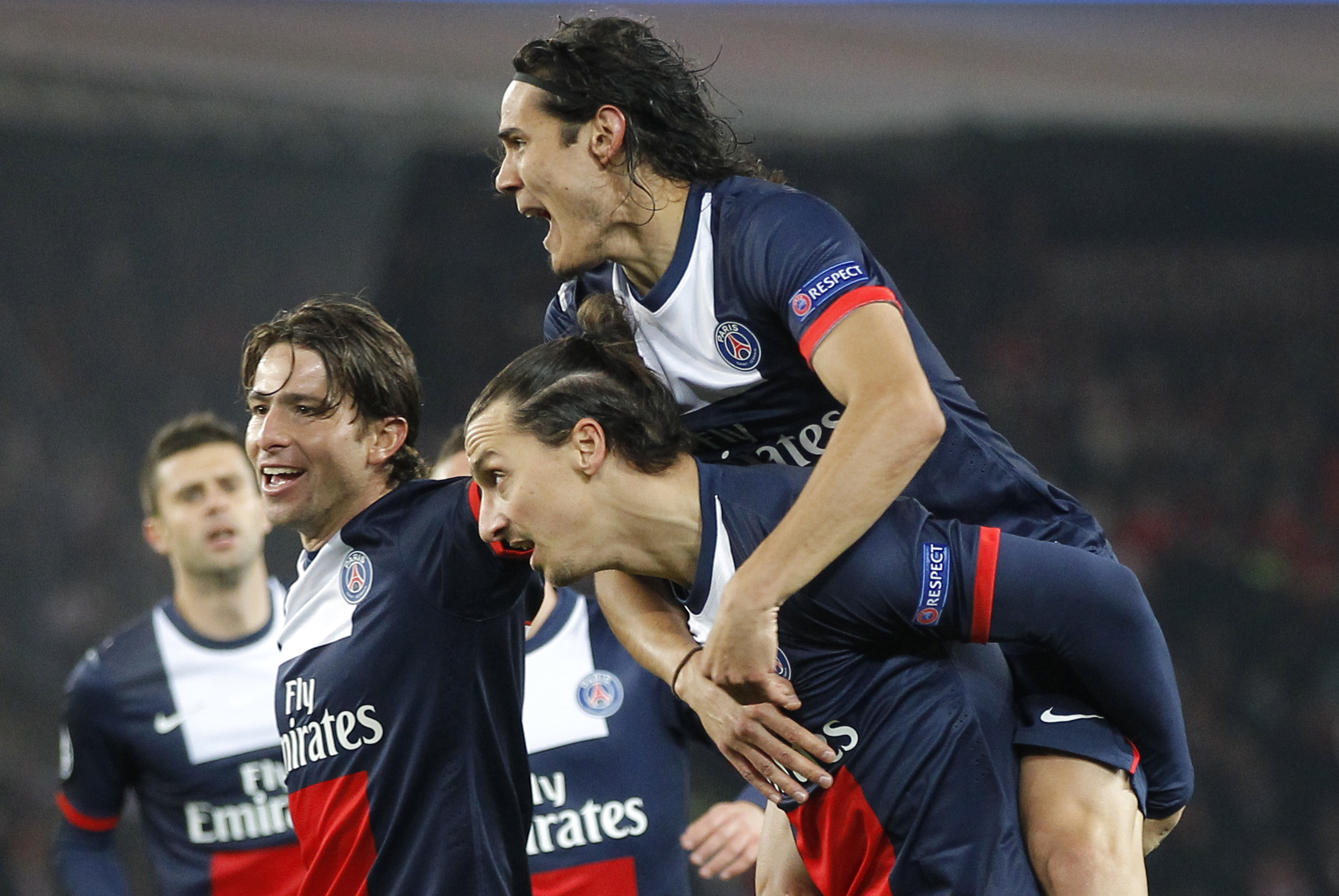 PSG's Zlatan Ibrahimovic, center, carries teammate Edinson Cavani after Ibrahimovic scored the opening goal during the Group C Champions League soccer match between Paris Saint Germain and Olympiakos FC at the Parc des Princes stadium in Paris, Wednesday, Nov.27, 2013. (AP Photo/Michel Euler)