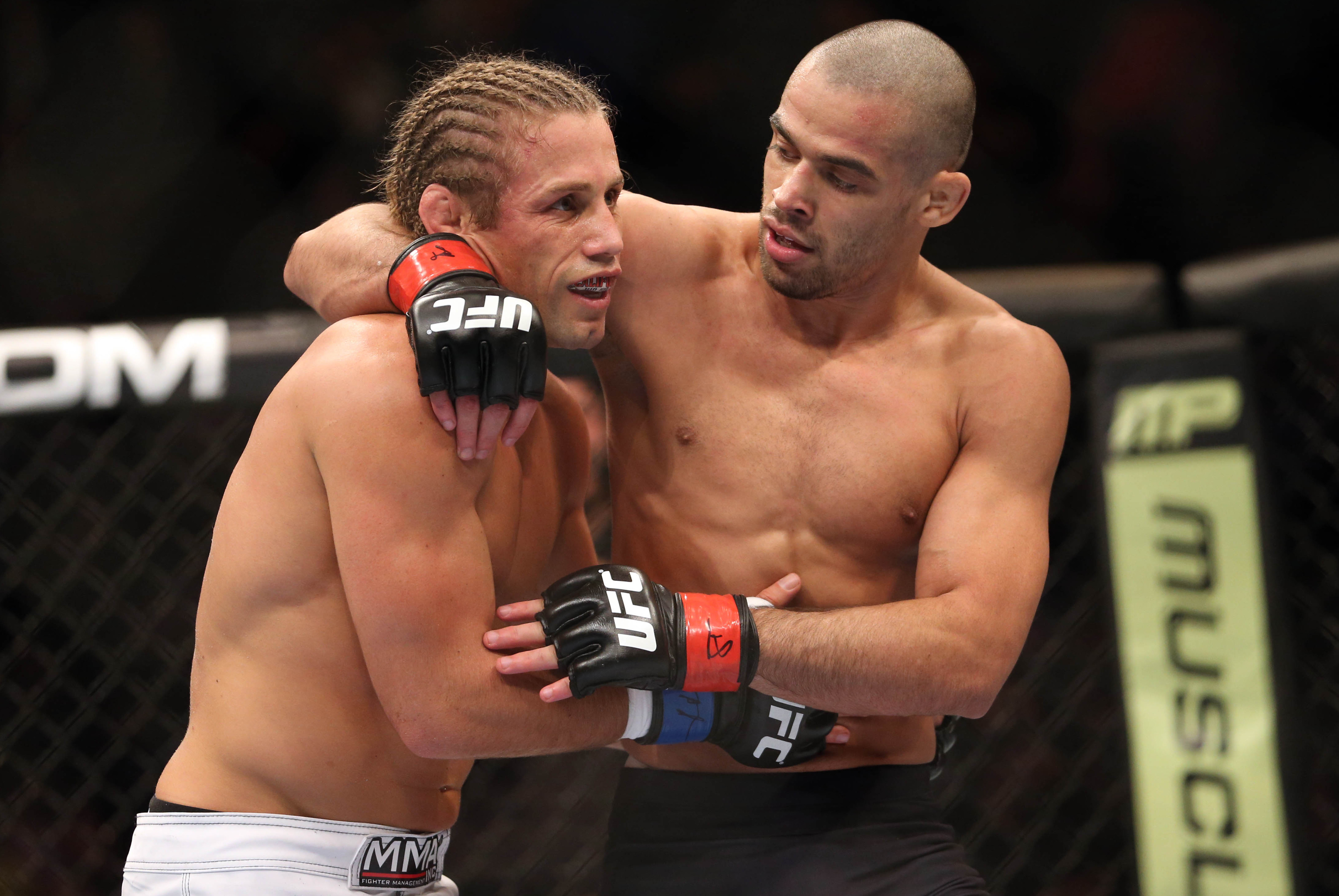 Feb 1, 2014; Newark, NJ, USA; Renan Barao (red gloves) and Urijah Faber (blue gloves) after their fight during UFC 169 at Prudential Center. Mandatory Credit: Joe Camporeale-USA TODAY Sports