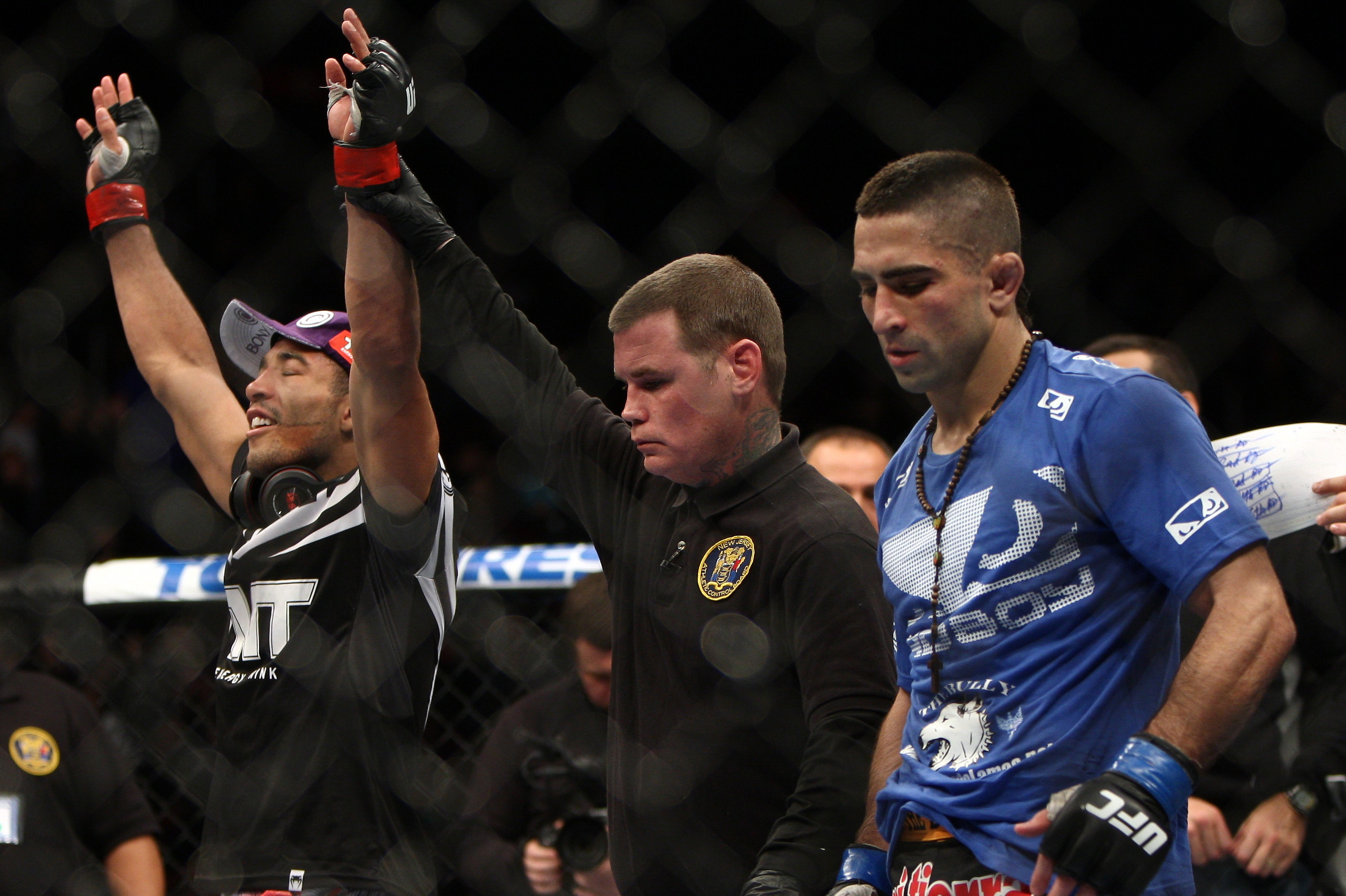 Jose Aldo, left of Brazil celebrates after beating Ricardo Lamas of Chicago, IL in five rounds of the Ultimate Fighting Featherweight Championship Mix Martial Arts bout in Newark, N.J. on Saturday, Feb. 1, 2014. Aldo won by unanimous decision in five rounds. (AP Photo/Tim Larsen)