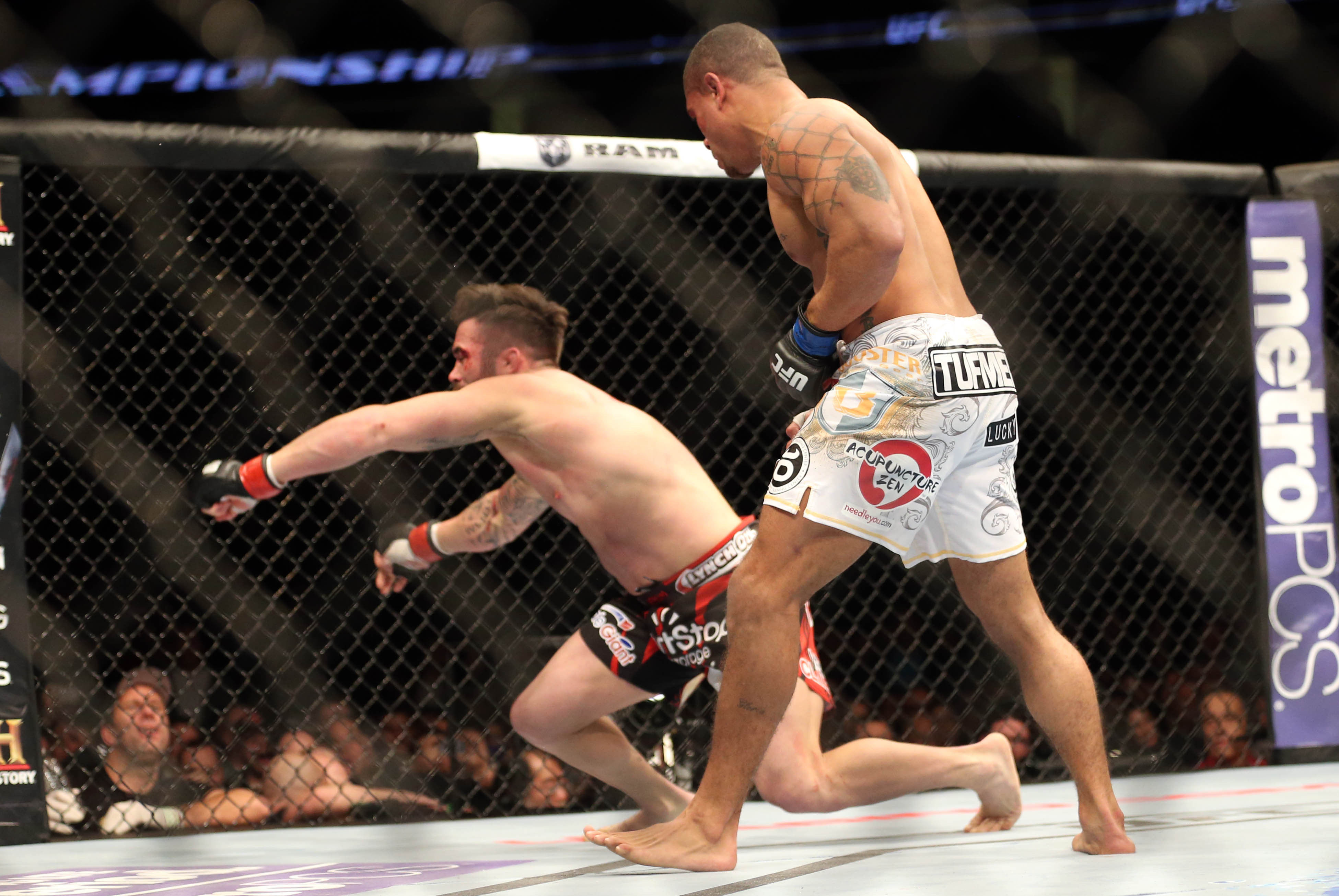 Feb 1, 2014; Newark, NJ, USA; Abel Trujillo (blue gloves) knocks out Jamie Varner (red gloves) during UFC 169 at Prudential Center. Mandatory Credit: Joe Camporeale-USA TODAY Sports