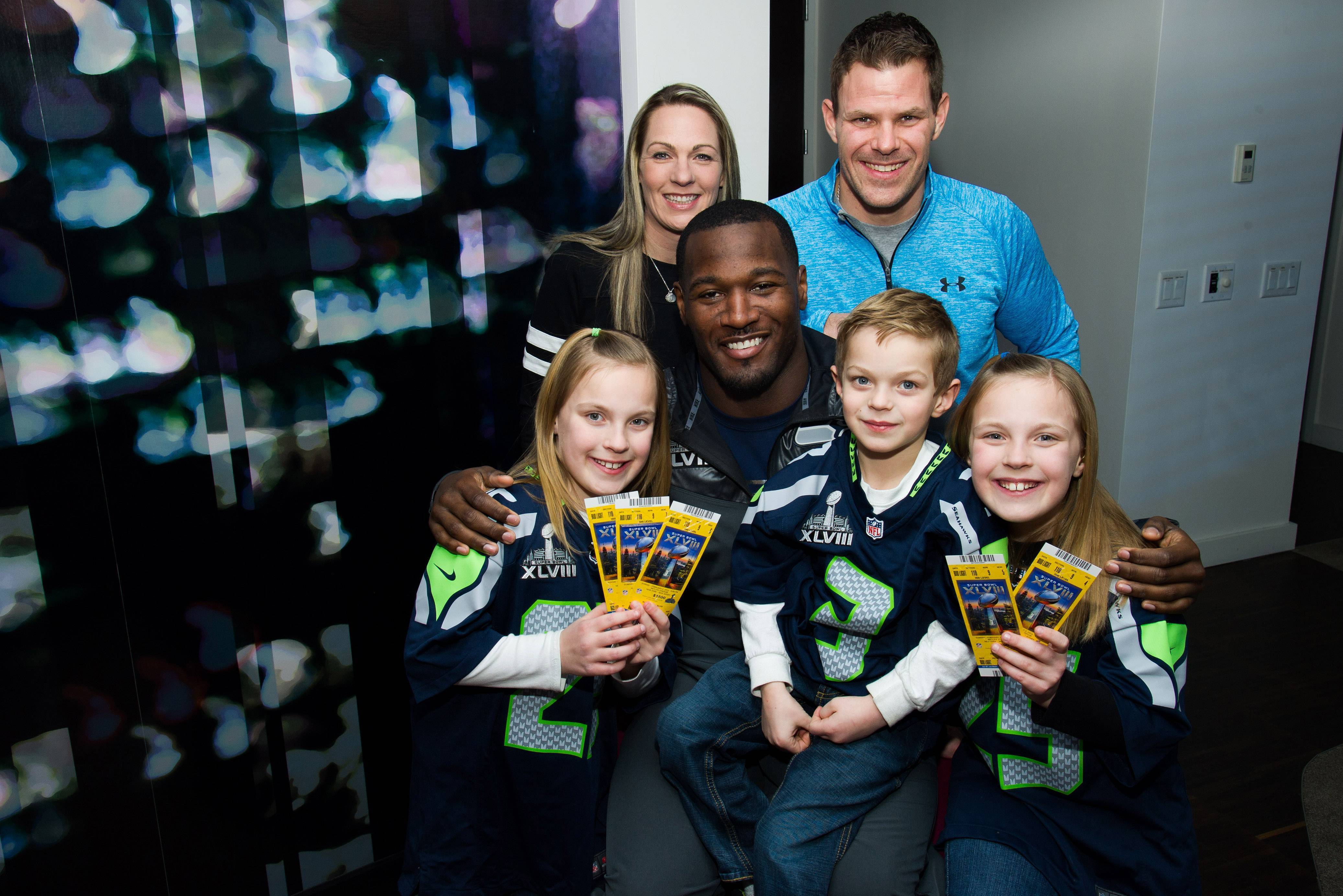 IMAGE DISTRIBUTED FOR DURACELL - On behalf of Duracell, Derrick Coleman of the Seattle Seahawks presented surprise tickets to Super Bowl XLVII to the Kovalcik family; from left, Erin Kovalcik, Tracy Kovalcik, Derrick Coleman, Aiden Kovalcik, Jake Kovalcik and Riley Kovalcik, on Tuesday, Jan. 28, 2014 in Hoboken, N.J. The twins and Derrick exchanged letters via Twitter after seeing Coleman in this Duracell