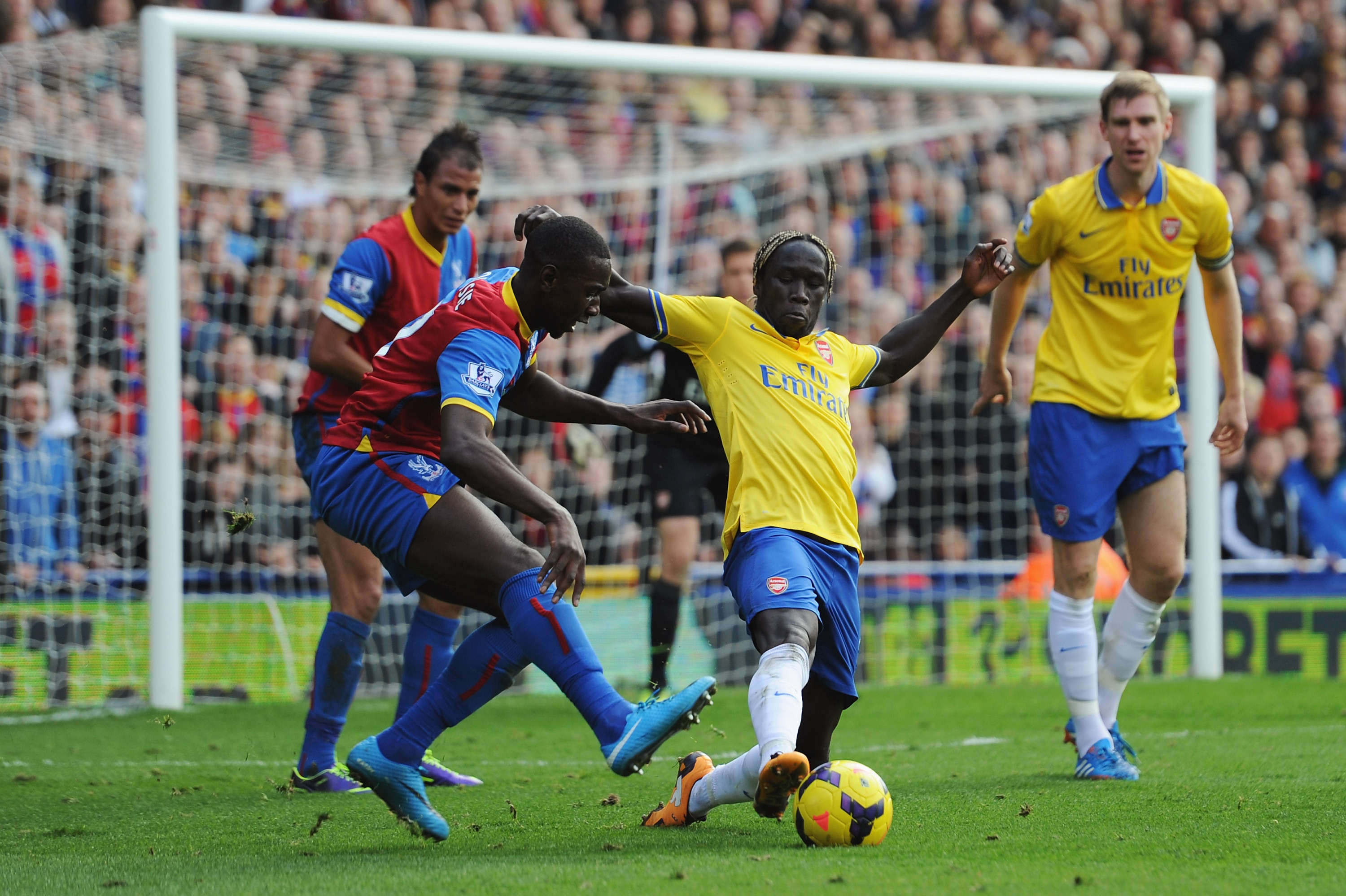 LONDON, ENGLAND - OCTOBER 26: Bacary Sagna of Arsenal is challenged by Yannick Bolasie of Crystal Palace during the Barclays Premier League match between Crystal Palace and Arsenal at Selhurst Park on October 26, 2013 in London, England.  (Photo by Shaun Botterill/Getty Images)