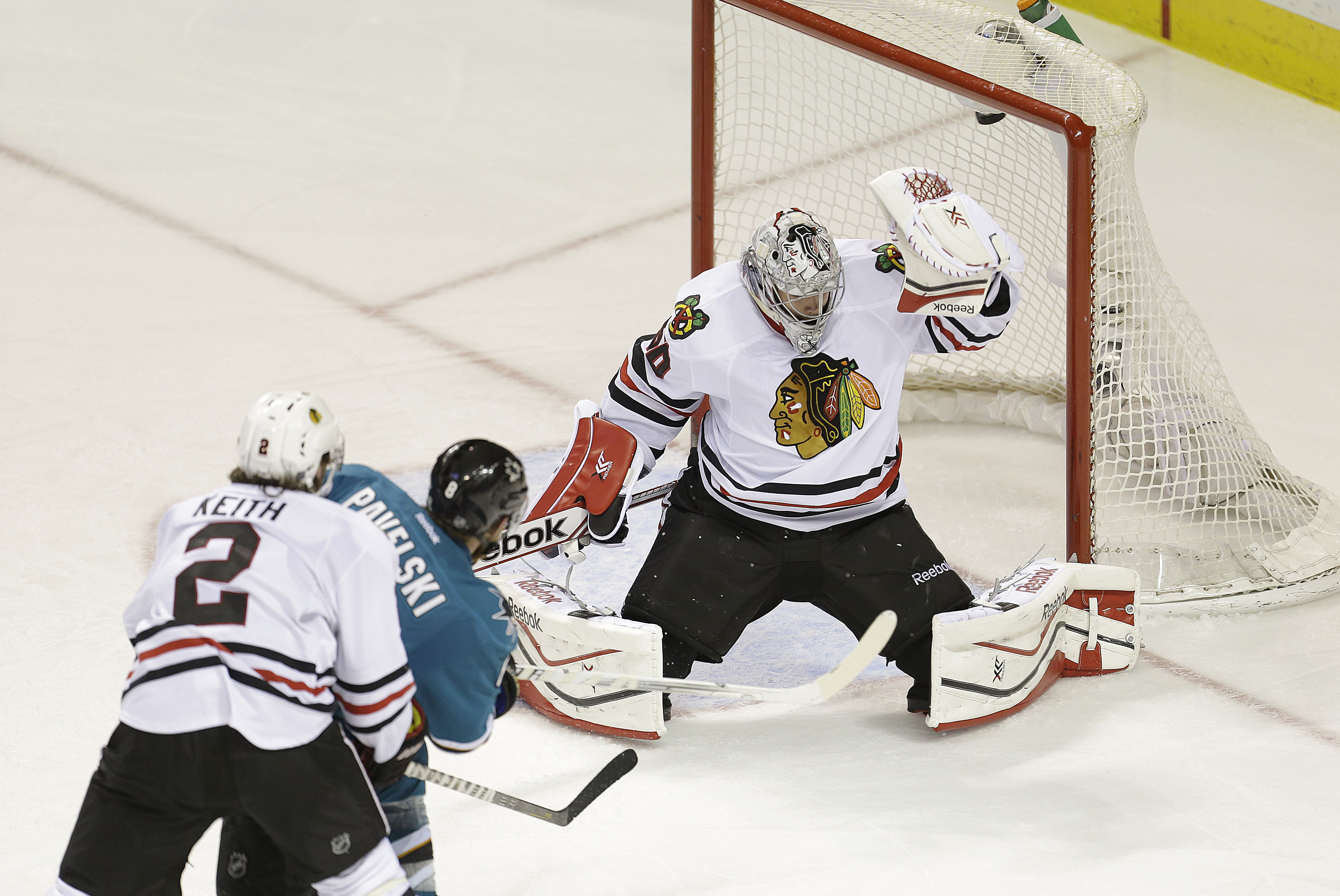 San Jose Sharks center Joe Pavelski (8) scores a goal past Chicago Blackhawks goalie Corey Crawford (50) during the third period of an NHL hockey game in San Jose, Calif., Saturday, Feb. 1, 2014. Sharks won in a shoot-out 3-2. (AP Photo/Tony Avelar)