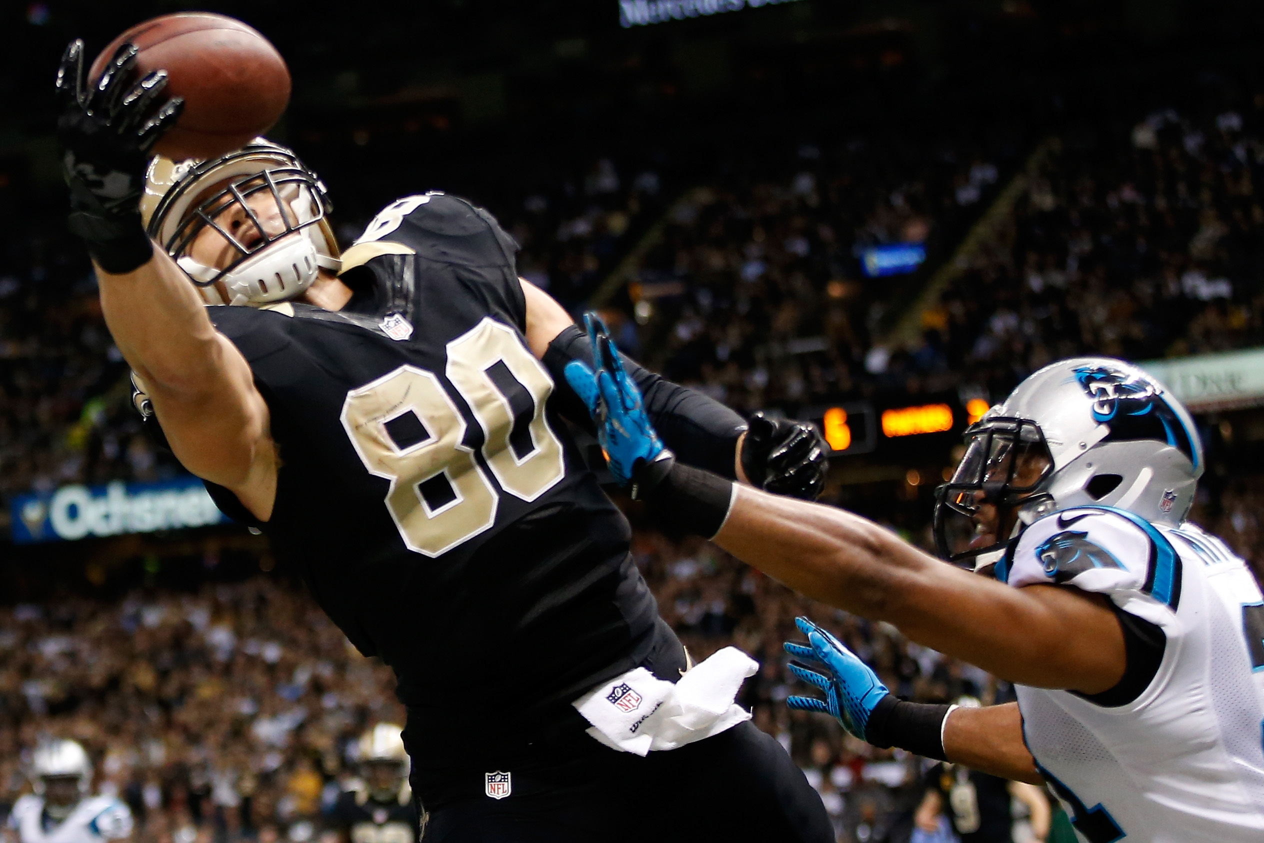 NEW ORLEANS, LA - DECEMBER 08:  Jimmy Graham #80 of the New Orleans Saints has a pass broken up by  Mike Mitchell #21 of the Carolina Panthers at Mercedes-Benz Superdome on December 8, 2013 in New Orleans, Louisiana.  (Photo by Chris Graythen/Getty Images)