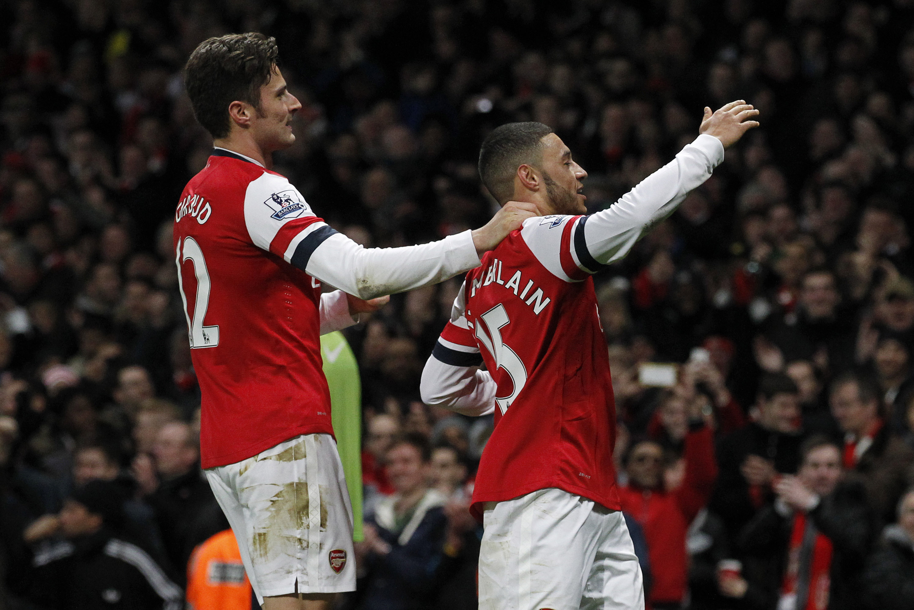 Arsenal's Alex Oxlade-Chamberlain, right, celebrates his his second against Crystal Palace with teammate Olivier Giroud during their English Premier League soccer match at Emirates Stadium in London, Sunday, Feb. 2, 2014. (AP Photo/Sang Tan)
