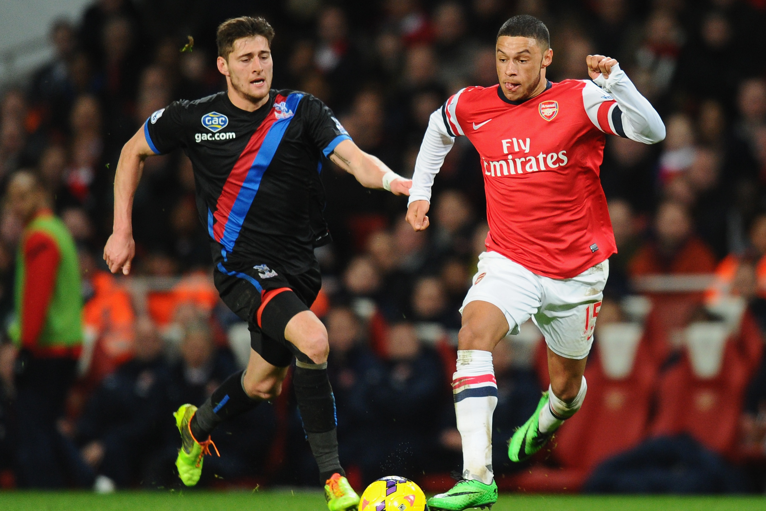 LONDON, ENGLAND - FEBRUARY 02:  Alex Oxlade-Chamberlain of Arsenal gets past Joel Ward of Crystal Palace on his way to scoring his second goal of Crystal Palace during the Barclays Premier League match between Arsenal and Crystal Palace at Emirates Stadium on February 2, 2014 in London, England.  (Photo by Mike Hewitt/Getty Images)