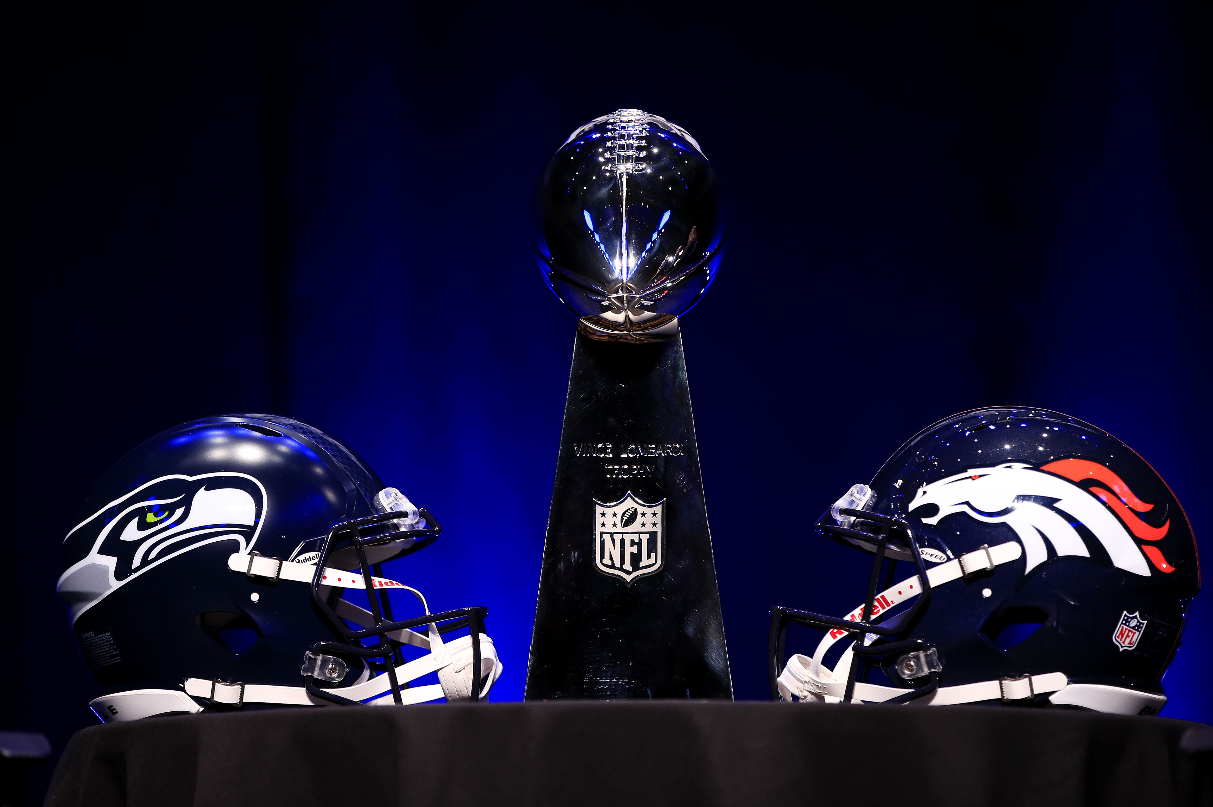 NEW YORK, NY - JANUARY 31:  The Vince Lombardi Trophy and helmets for the Denver Broncos and the Seattle Seahawks are displayed prior to a Super Bowl XLVIII head coach joint press conference at the Rose Theater in Jazz at Lincoln Center on January 31, 2014 in New York City.  (Photo by Jamie Squire/Getty Images)