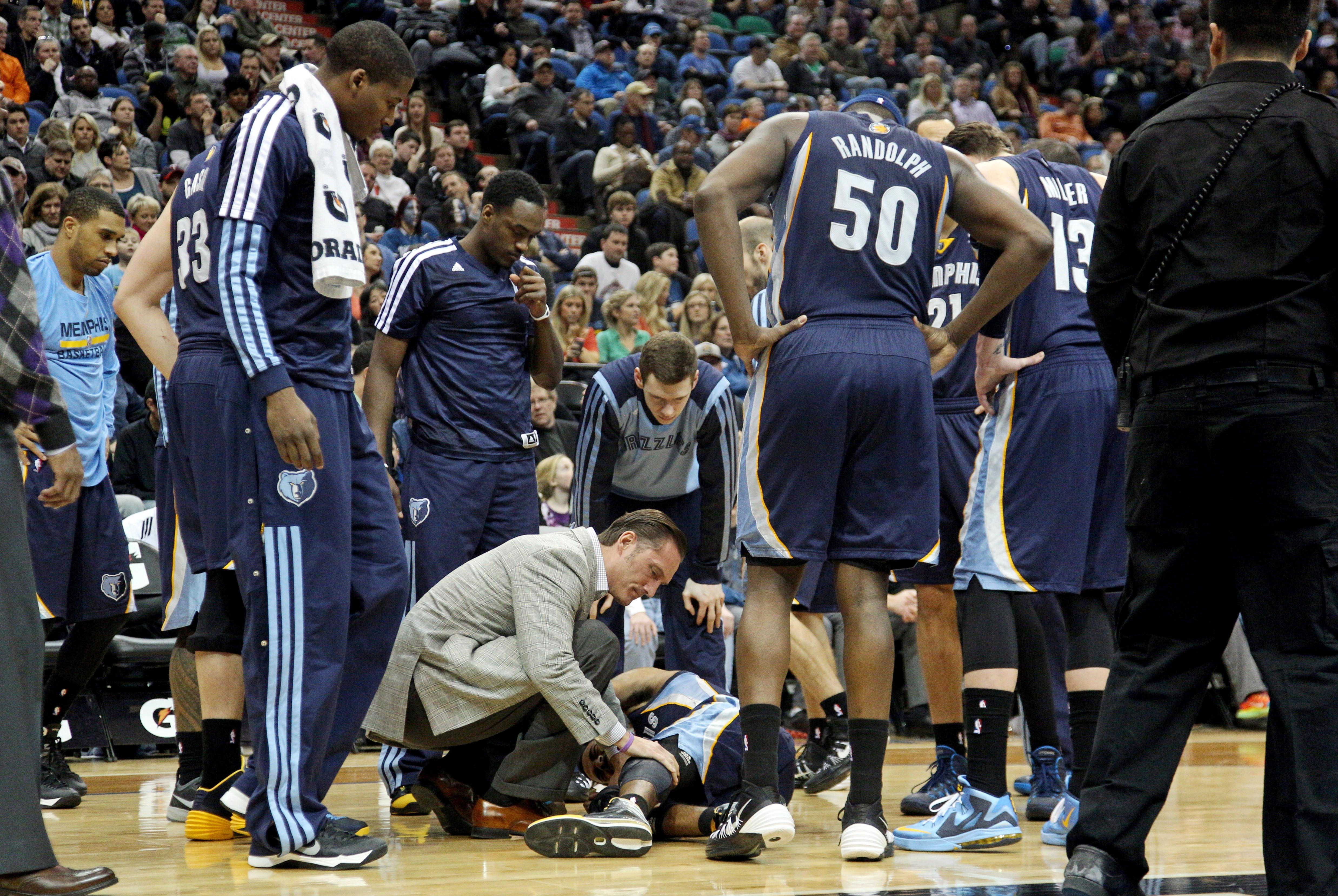 Jan 31, 2014; Minneapolis, MN, USA; Teammates look on Memphis Grizzlies guard Mike Conley (11) injured his ankle during the fourth quarter against the Minnesota Timberwolves at Target Center. The Grizzlies defeated the Timberwolves 94-90. Mandatory Credit: Brace Hemmelgarn-USA TODAY Sports