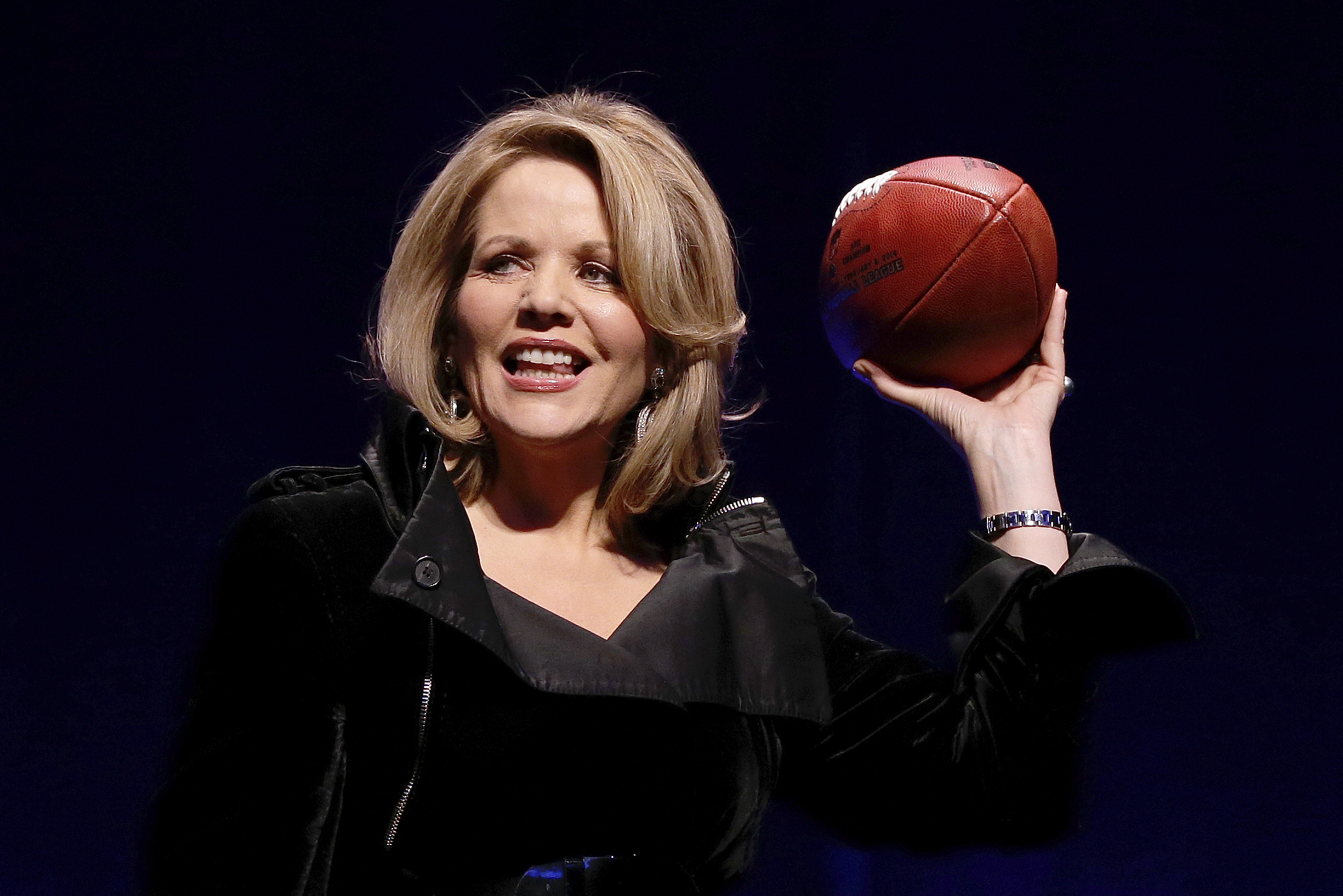 Opera singer Renee Fleming who will sing the National Anthem before the NFL Super Bowl XLVIII football game holds the game ball during a press conference Thursday, Jan. 30, 2014, in New York. (AP Photo)
