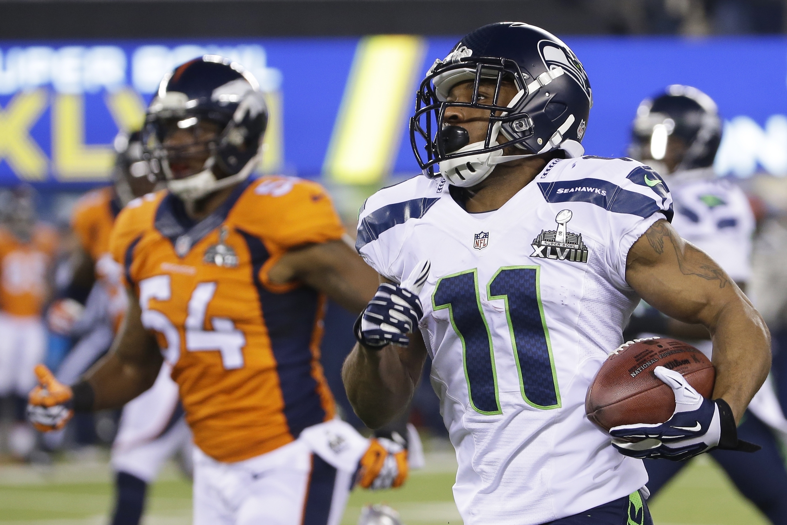 Seattle Seahawks' Percy Harvin (11) returns a kickoff 87-yards for a touchdown during the second half of the NFL Super Bowl XLVIII football game against the Denver Broncos Sunday, Feb. 2, 2014, in East Rutherford, N.J. (AP Photo/Matt Slocum)