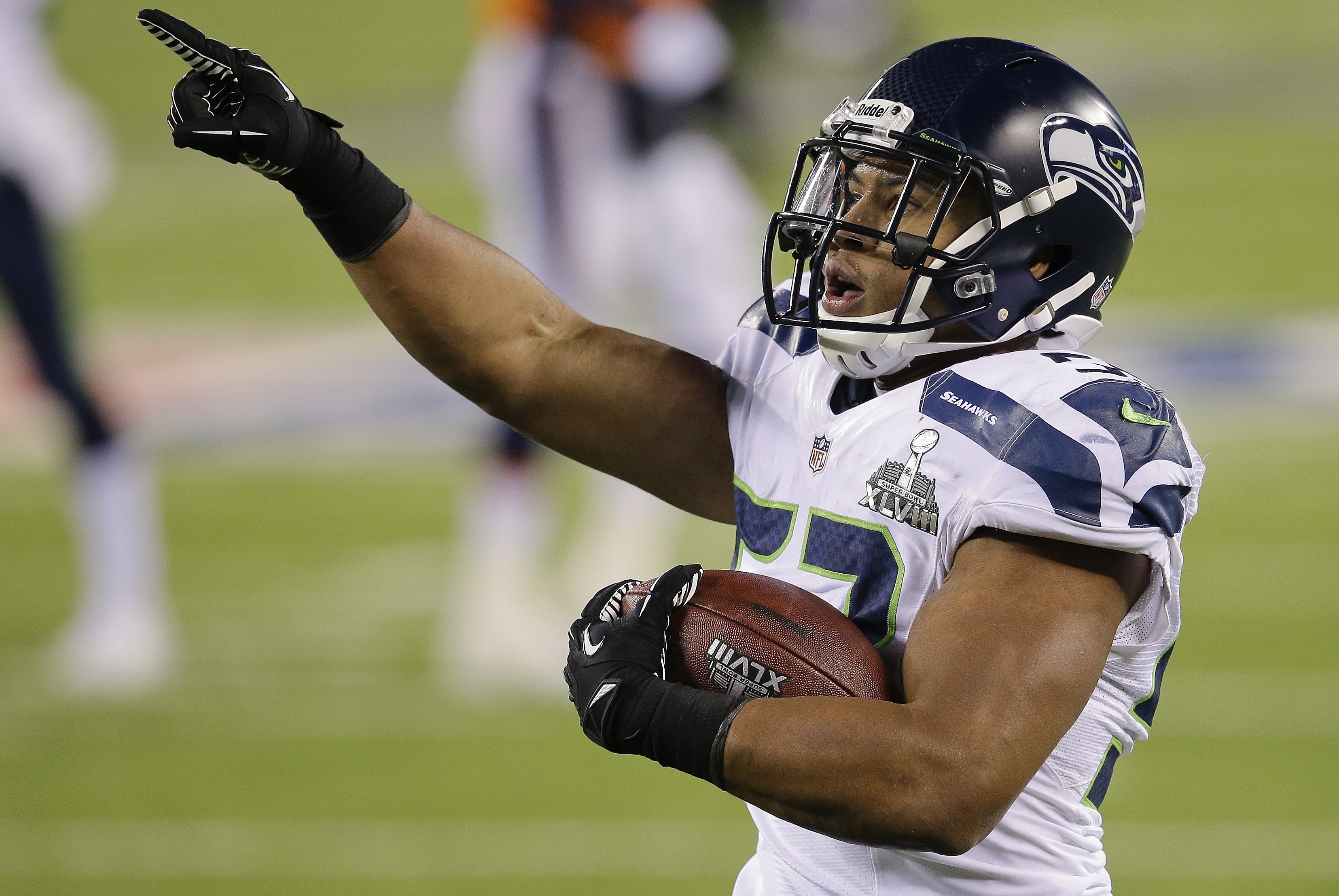 Seattle Seahawks outside linebacker Malcolm Smith (53) reacts after running back an interception for a touchdown against the Denver Broncos during the first half of the NFL Super Bowl XLVIII football game, Sunday, Feb. 2, 2014, in East Rutherford, N.J. (AP Photo/Chris O'Meara)