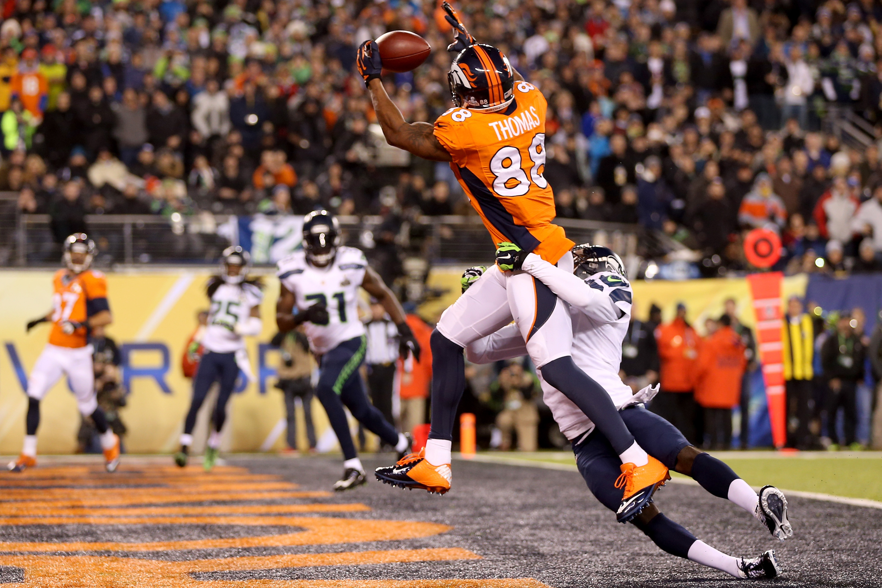 EAST RUTHERFORD, NJ - FEBRUARY 02:  Wide receiver Demaryius Thomas #88 of the Denver Broncos ran 14 yards to score a touchdown in the third quarter against cornerback Byron Maxwell #41 of the Seattle Seahawks during Super Bowl XLVIII at MetLife Stadium on February 2, 2014 in East Rutherford, New Jersey.  (Photo by Jeff Gross/Getty Images)