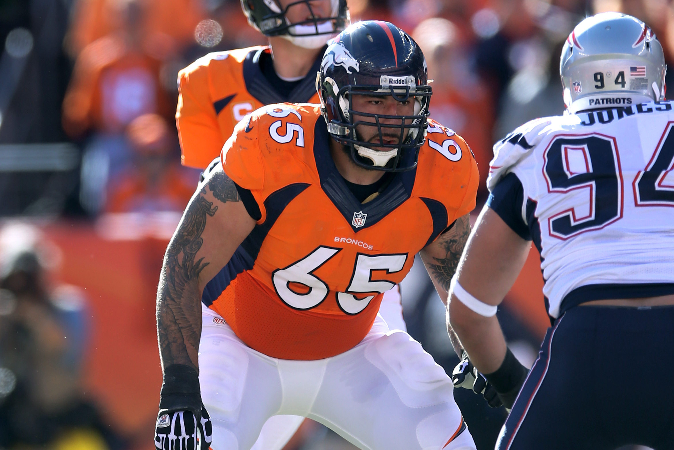 Jan 19, 2014; Denver, CO, USA; Denver Broncos guard Louis Vasquez (65) blocks for quarterback Peyton Manning (18) against the New England Patriots during the 2013 AFC Championship football game at Sports Authority Field at Mile High. Mandatory Credit: Mark J. Rebilas-USA TODAY Sports