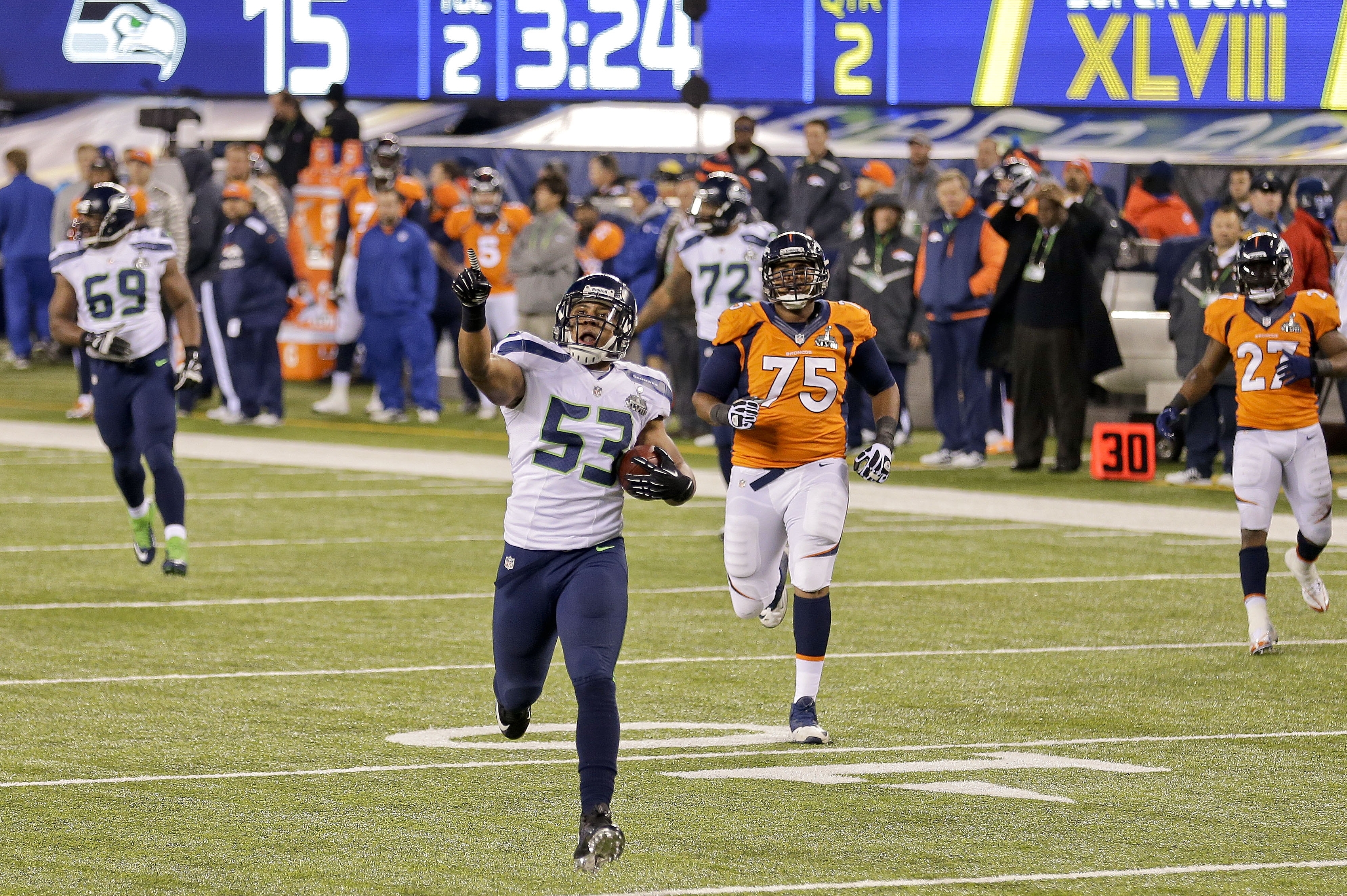 Seattle Seahawks outside linebacker Malcolm Smith (53) reacts as he returns an interception for a touchdown against the Denver Broncos during the first half of the NFL Super Bowl XLVIII football game, Sunday, Feb. 2, 2014, in East Rutherford, N.J. (AP Photo/Gregory Bull)