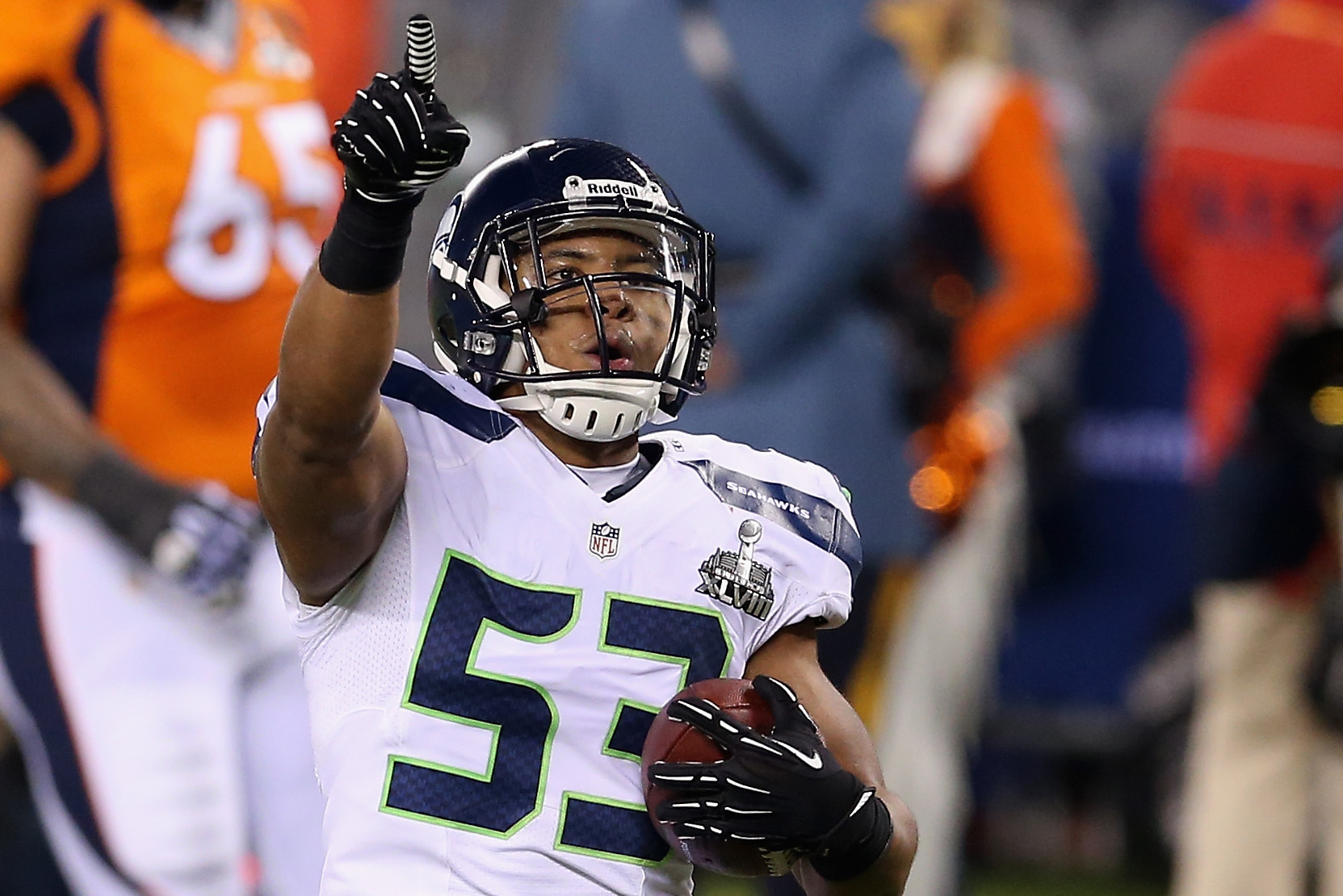 EAST RUTHERFORD, NJ - FEBRUARY 02:  Outside linebacker Malcolm Smith #53 of the Seattle Seahawks celebrates running back an interception off quarterback Peyton Manning of the Denver Broncos during the second quarter of Super Bowl XLVIII at MetLife Stadium on February 2, 2014 in East Rutherford, New Jersey.  (Photo by Christian Petersen/Getty Images)