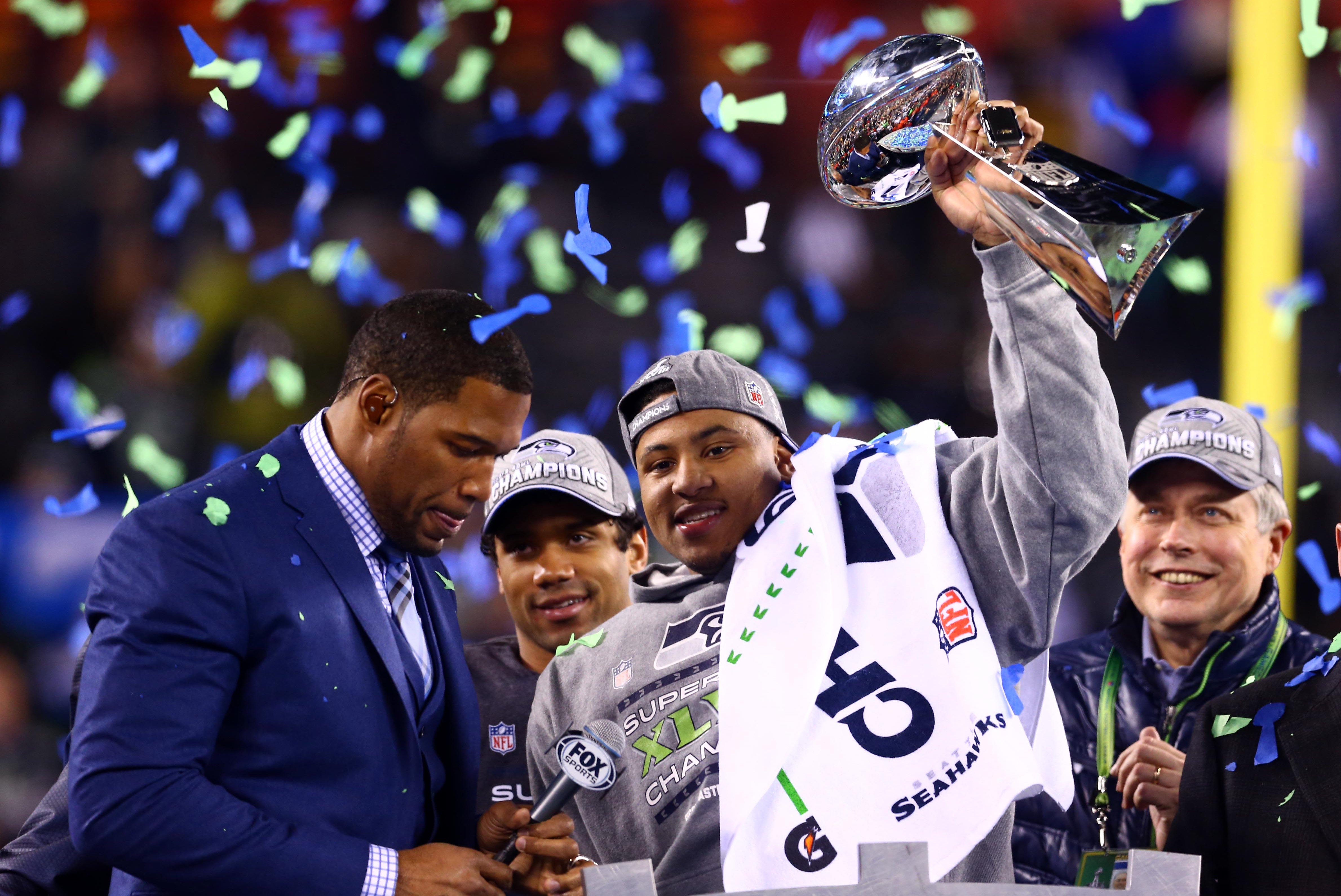 Feb 2, 2014; East Rutherford, NJ, USA; Seattle Seahawks outside linebacker Malcolm Smith holds the Vince Lombardi Trophy after Super Bowl XLVIII against the Denver Broncos at MetLife Stadium.  Mandatory Credit: Mark J. Rebilas-USA TODAY Sports