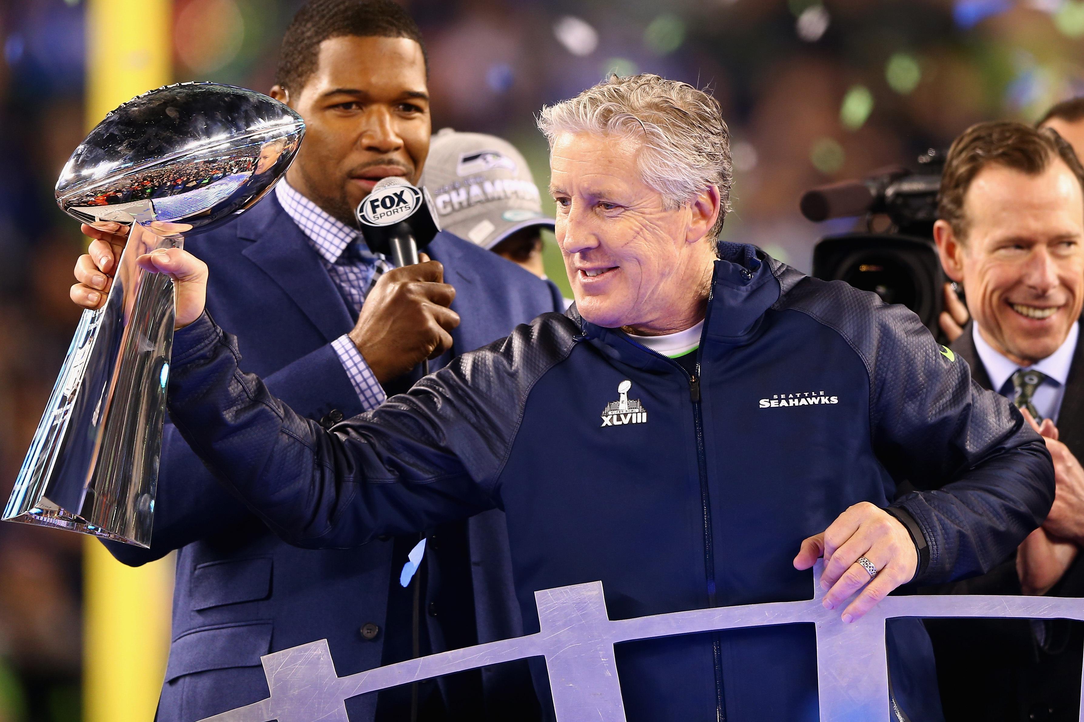 EAST RUTHERFORD, NJ - FEBRUARY 02:  Head coach Pete Carroll of the Seattle Seahawks holds the Vince Lombardi Trophy after his team won Super Bowl XLVIII at MetLife Stadium on February 2, 2014 in East Rutherford, New Jersey. The Seahawks beat the Broncos 43-8.  (Photo by Elsa/Getty Images)